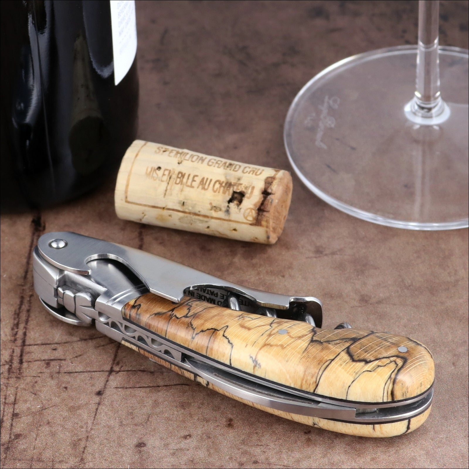 Laguiole Magnum Burled Beech Corkscrew, close-up of polished steel and natural wood grain handle.
