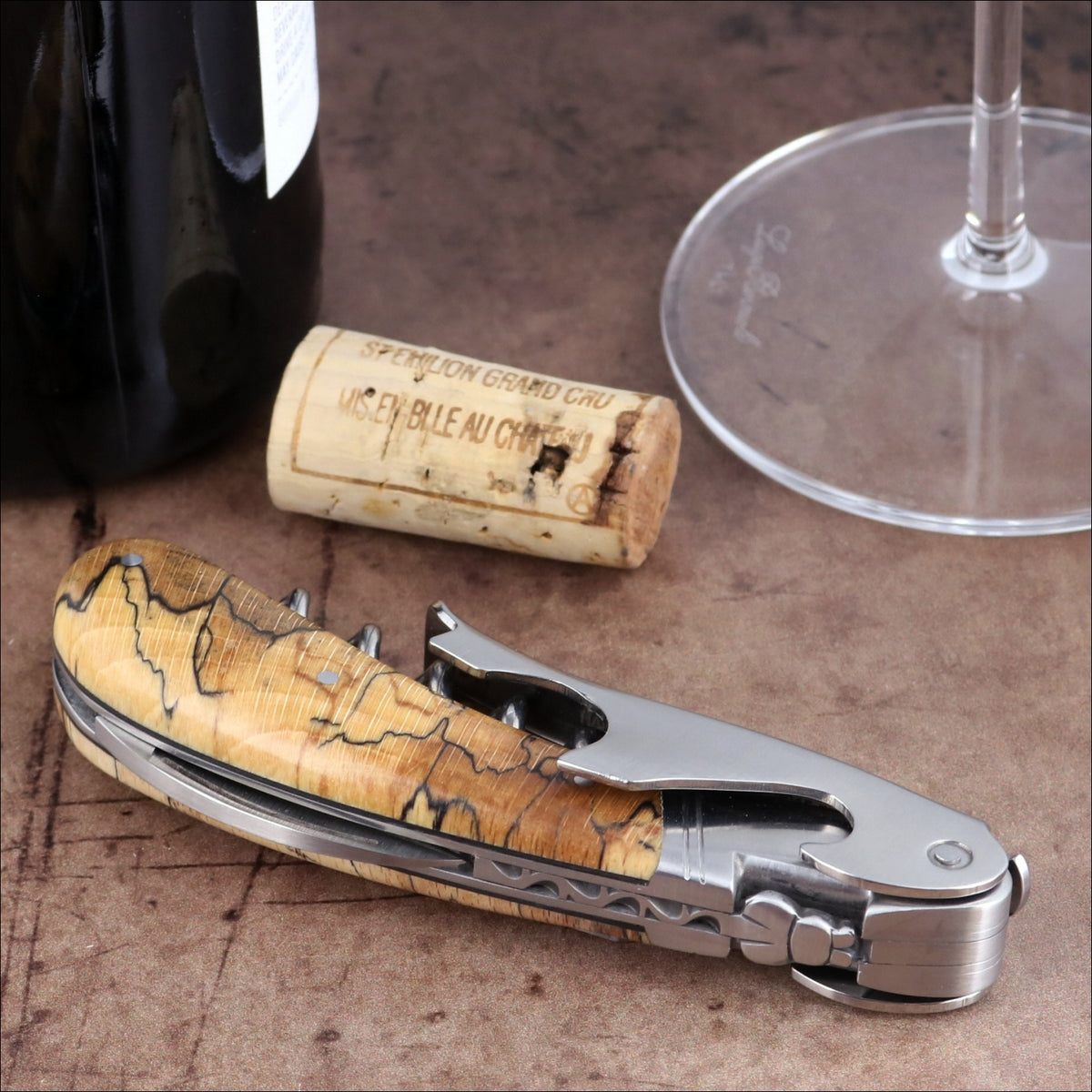 Laguiole Magnum Burled Beech Corkscrew, close-up side view showing wood grain and steel lever.