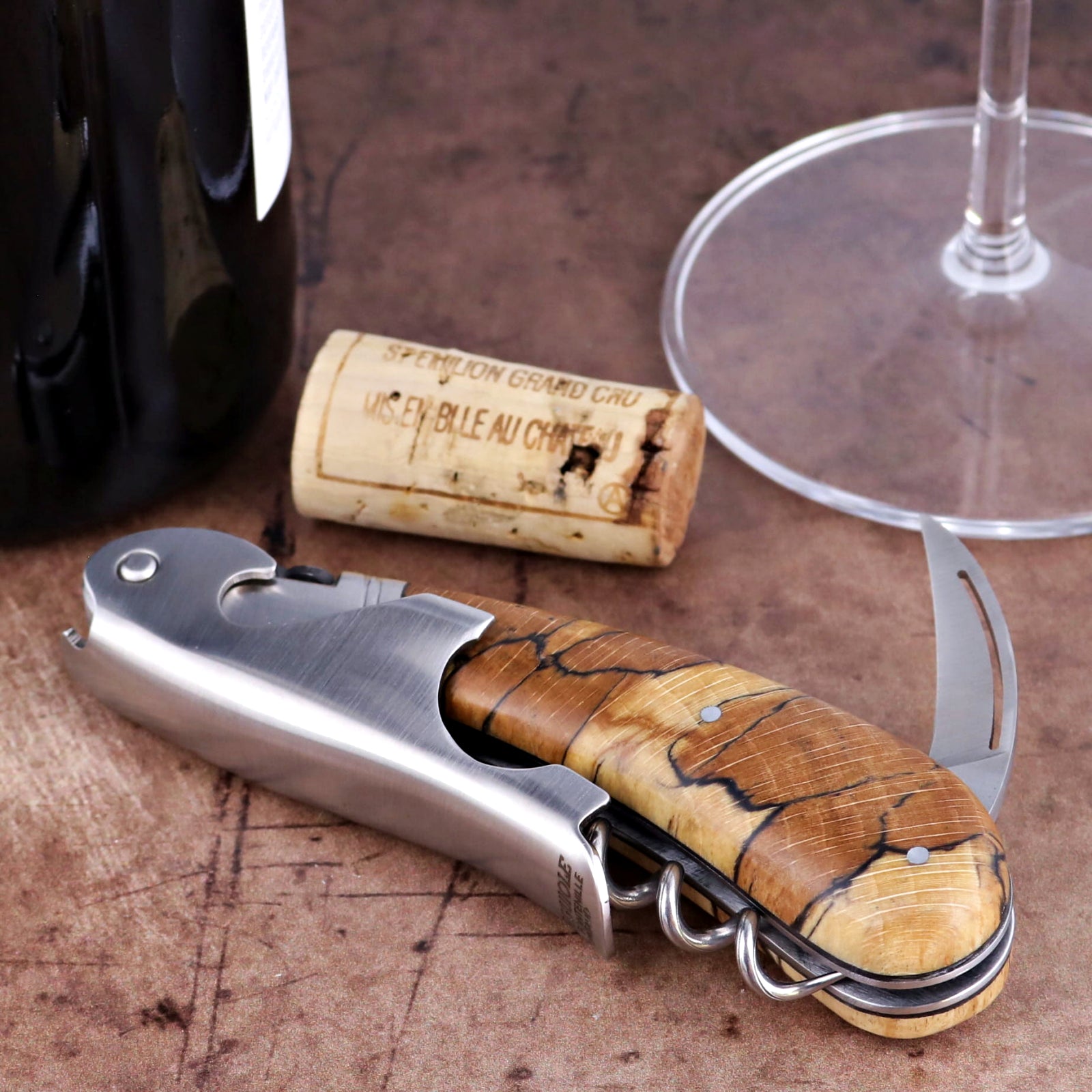 Laguiole Magnum Burled Beech Corkscrew close-up featuring a polished steel body and wood grain handle.