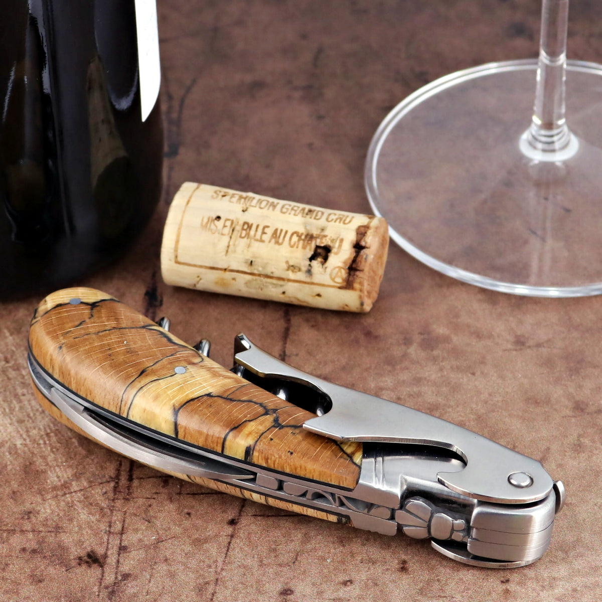 Laguiole Magnum Burled Beech Corkscrew close-up showing the polished steel and wood grain handle.