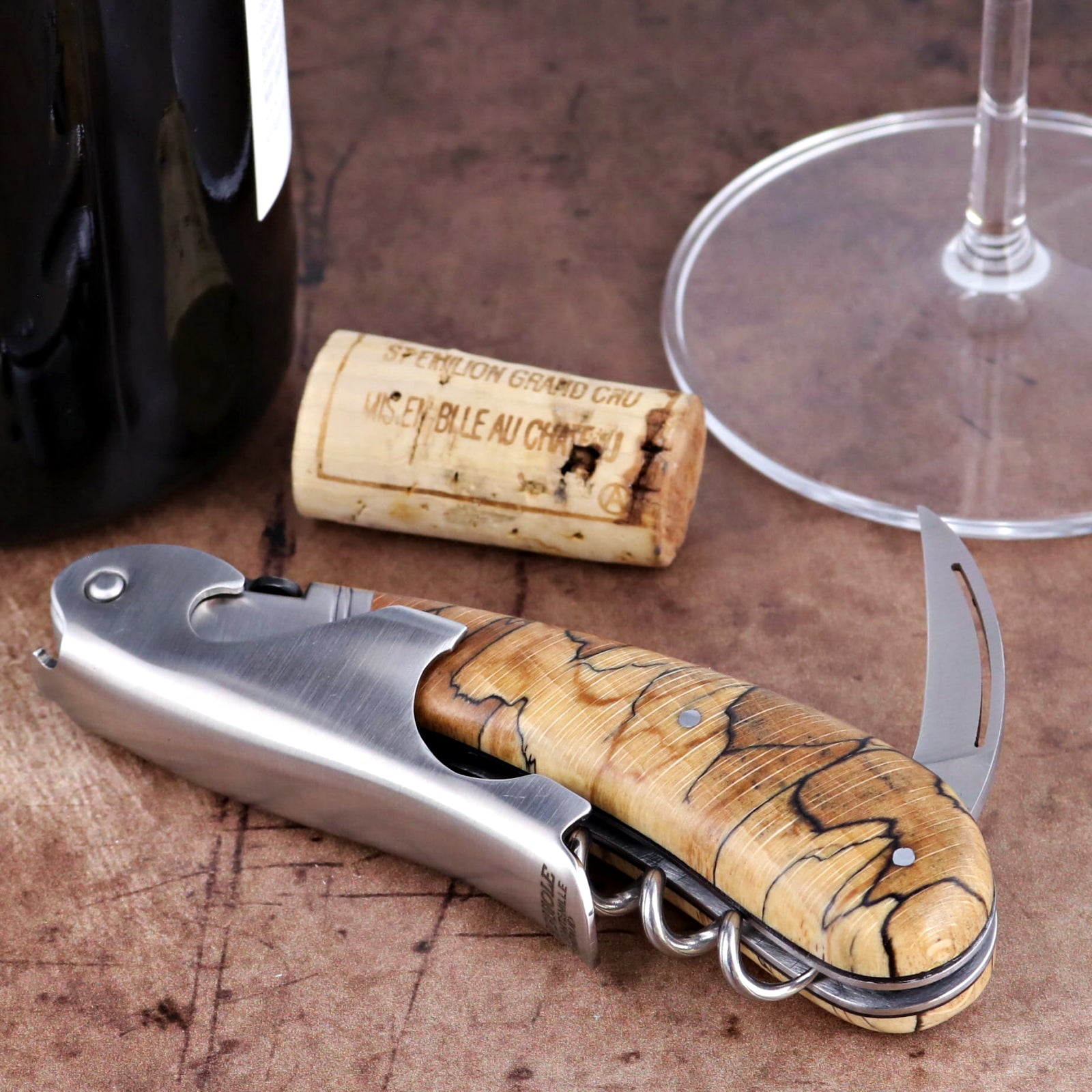 Laguiole Magnum Burled Beech corkscrew, close-up of polished steel and wood handle with foil cutter.
