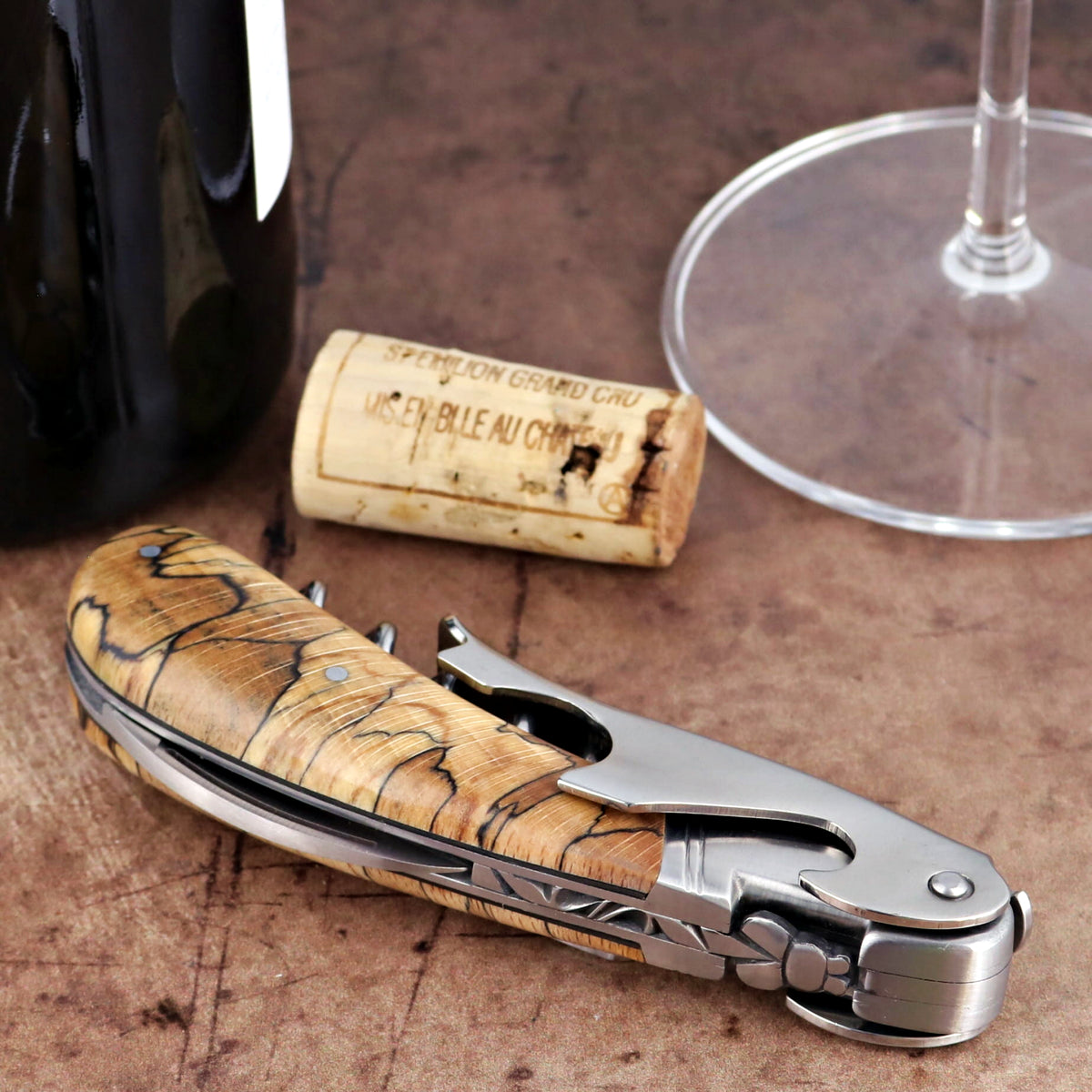 Laguiole Magnum Burled Beech Corkscrew, close-up of folded stainless steel and wood handle design.