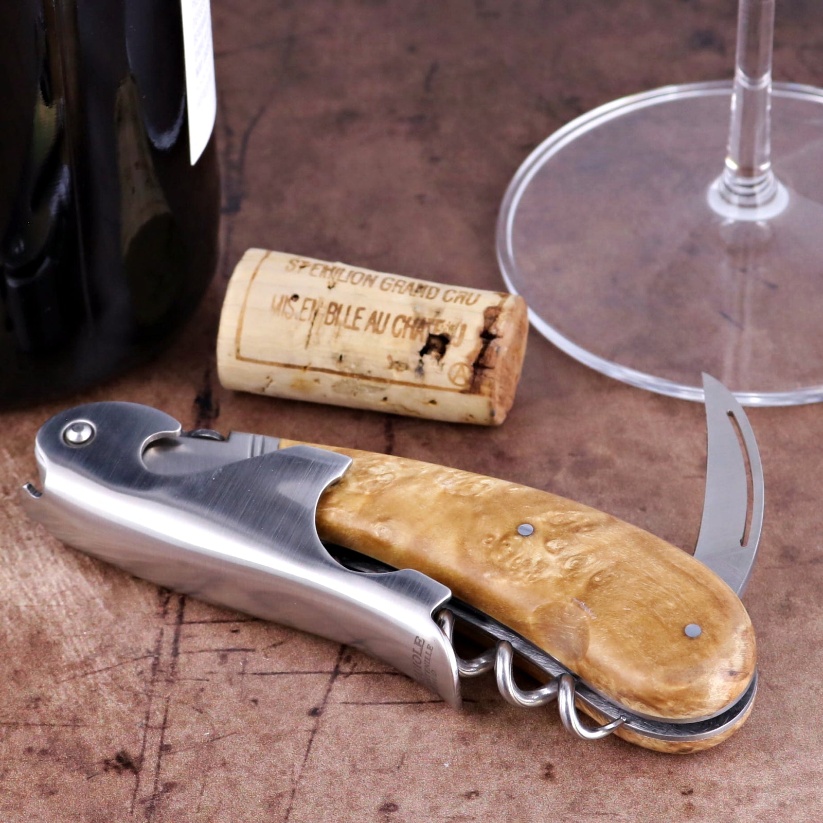 Laguiole Magnum Burled Maple Corkscrew, close-up of polished steel and light wood grain handle.