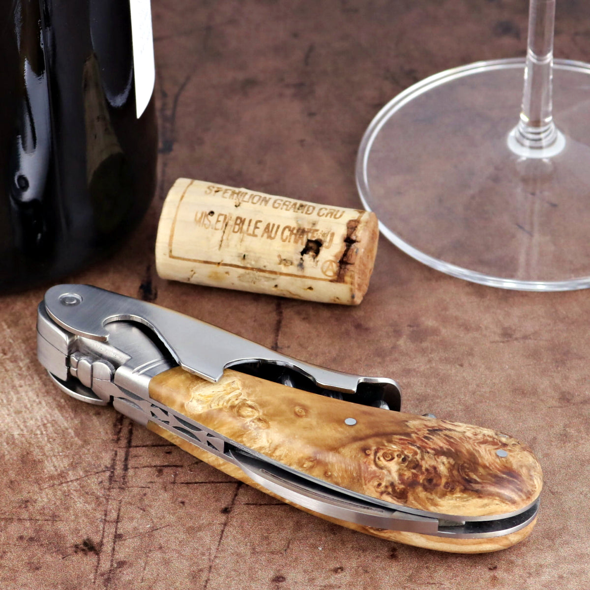 Laguiole Magnum Burled Maple Corkscrew, close-up of the polished steel and wood grain handle.