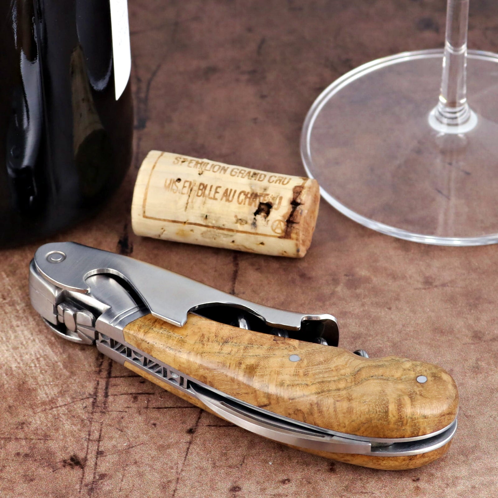 Laguiole Magnum Burled Maple Corkscrew, close-up of polished steel and wood handle with foil cutter.