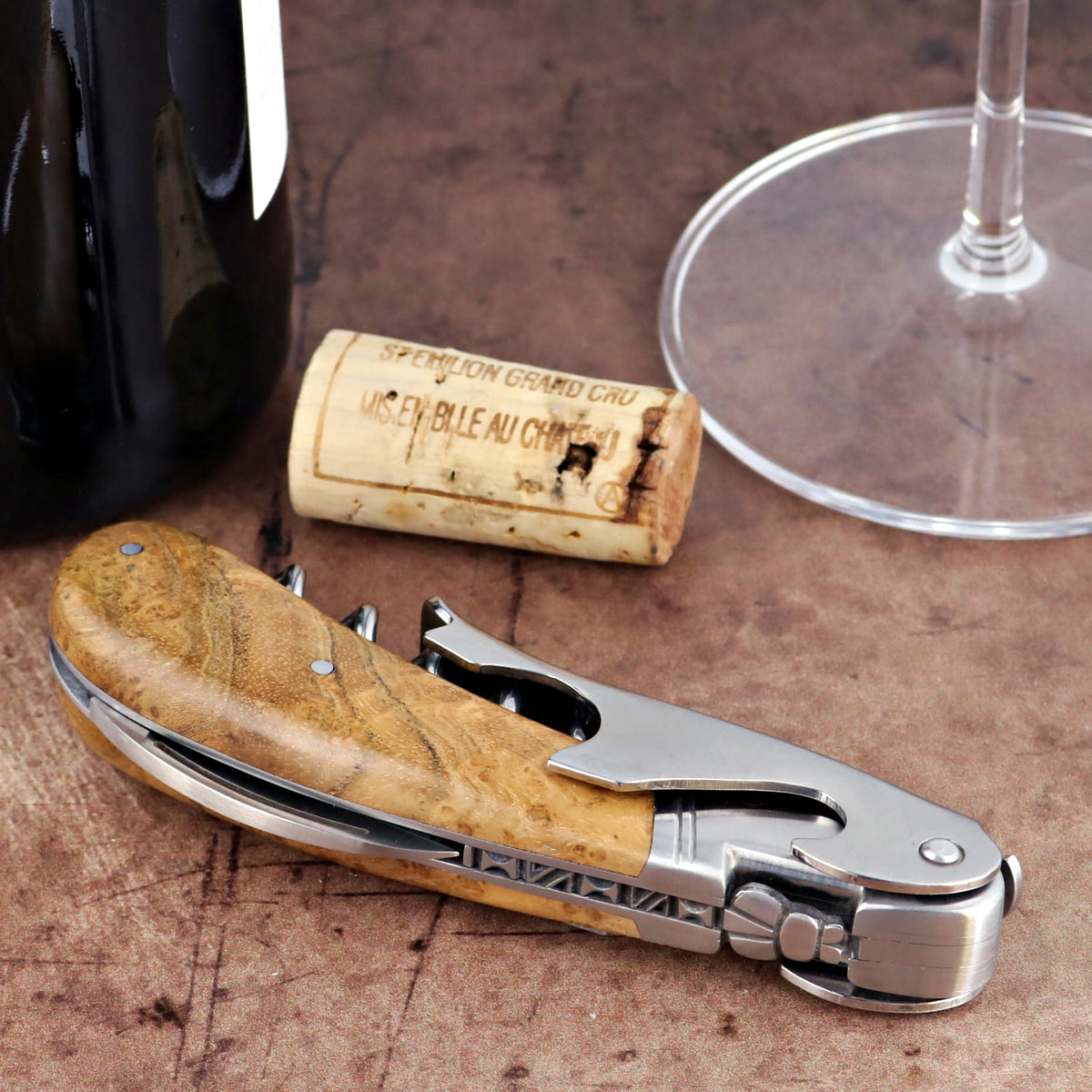 Laguiole Magnum Burled Maple Corkscrew, close-up side view of polished steel and wood handle.