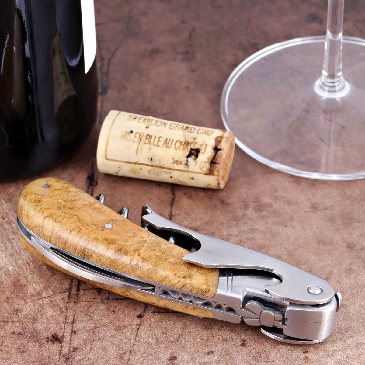 Laguiole Magnum Burled Maple Corkscrew, close-up side view showing polished steel and wood grain.