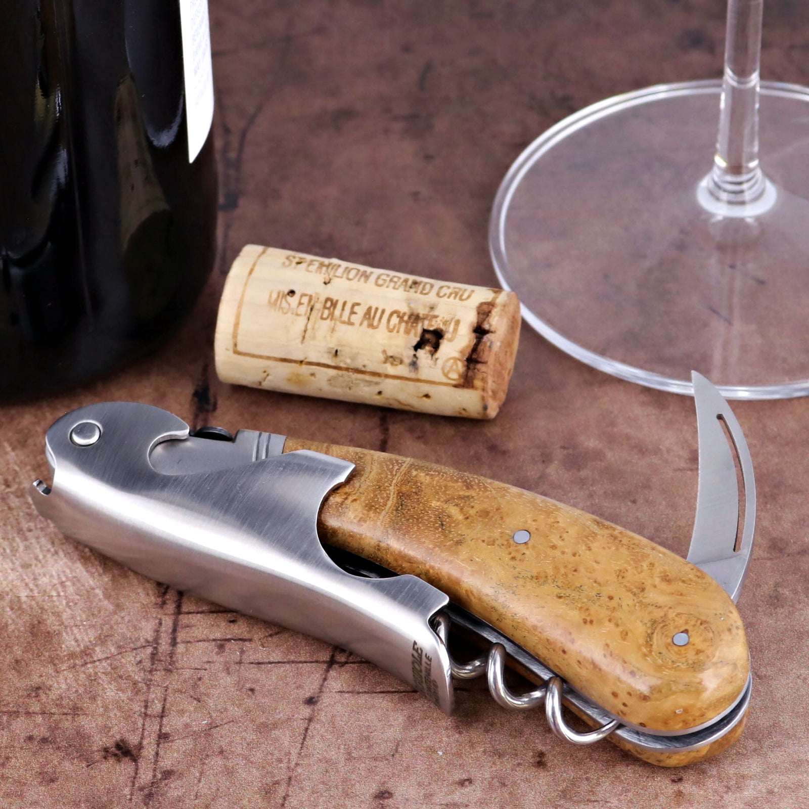 Laguiole Magnum Burled Maple Corkscrew, close-up of polished steel and tan wood grain handle.