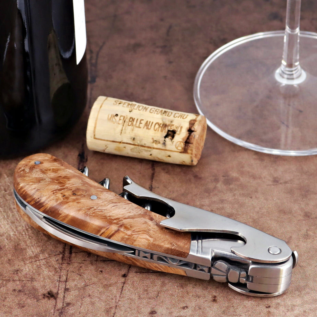 Laguiole Magnum Burled Teak Corkscrew, close-up of folded wood handle and polished steel mechanism.