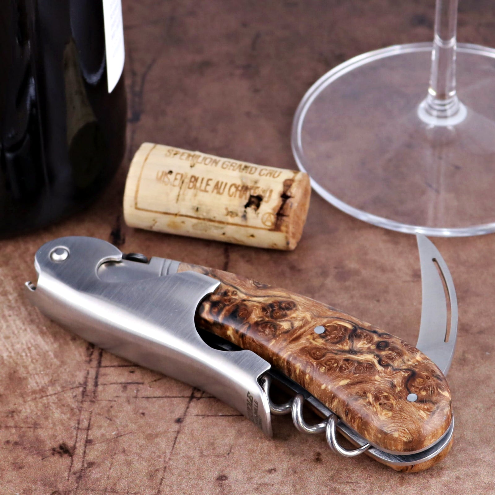 Laguiole Magnum Burled Teak Corkscrew, close-up of stainless steel tool with polished wood handle.
