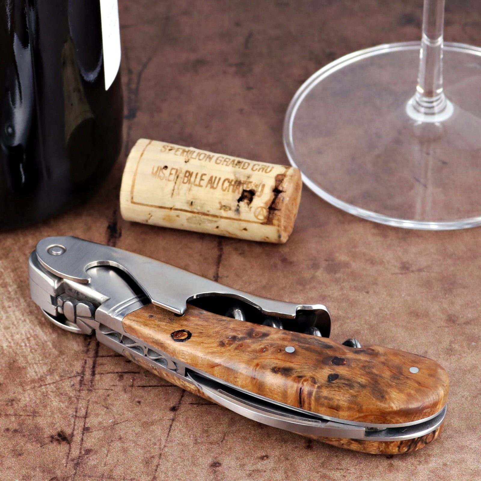 Laguiole Magnum Burled Teak Corkscrew, close-up of stainless steel tool with polished wood handle.