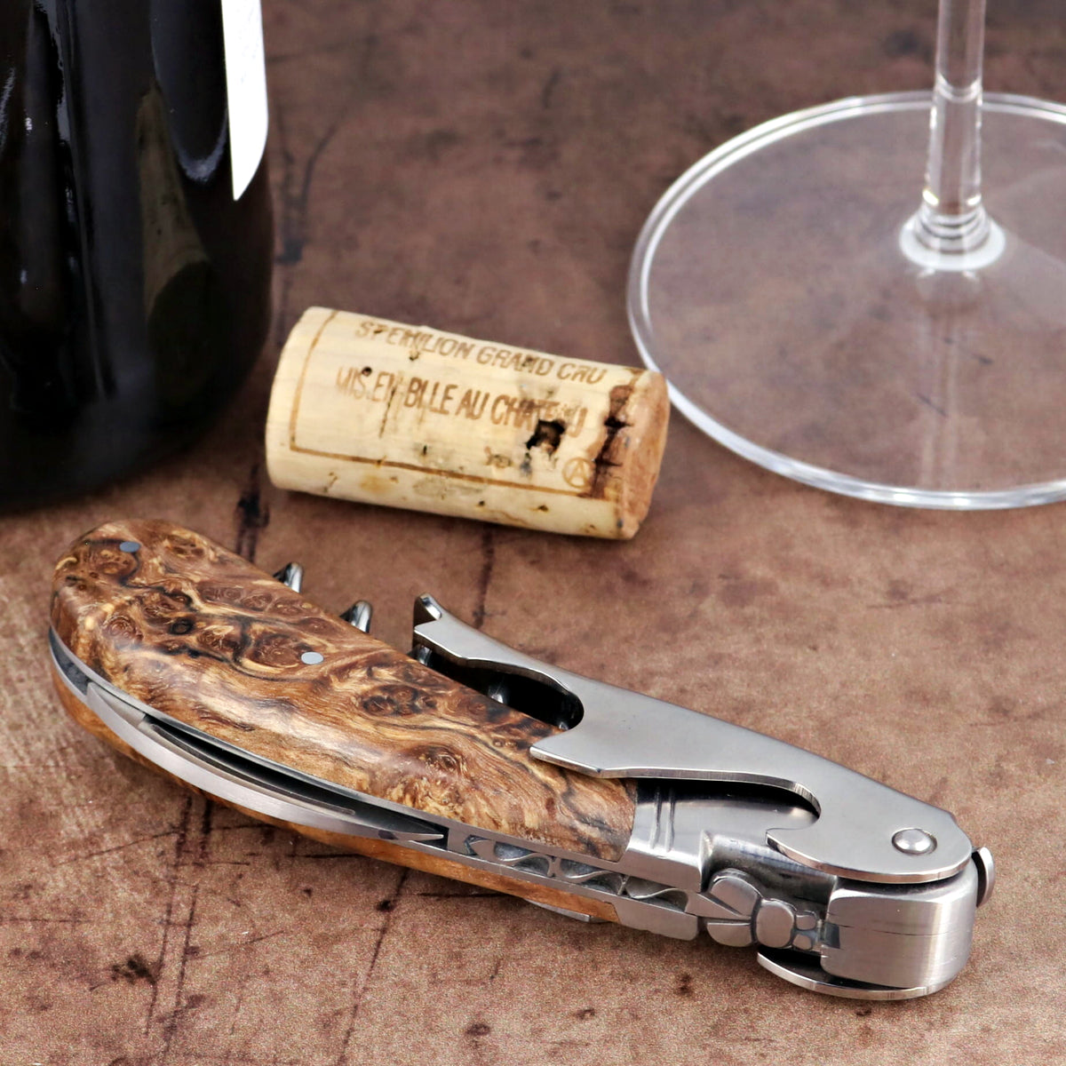 Laguiole Magnum Burled Teak Corkscrew, close-up side view showing polished steel and wood grain handle.