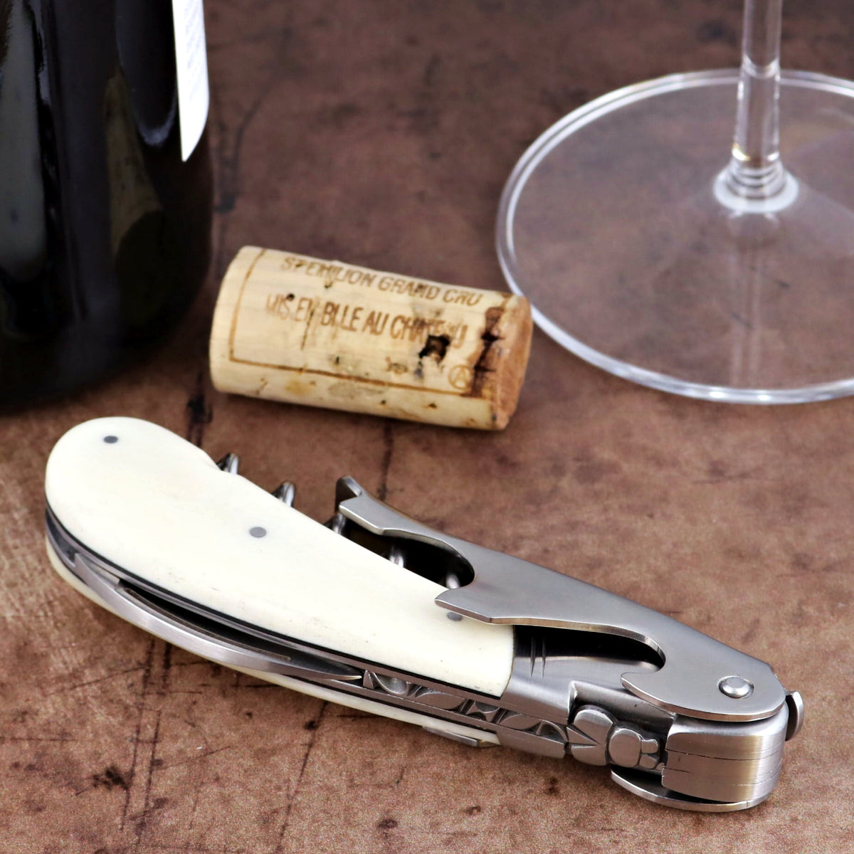 Laguiole Magnum Cattle Bone Handle Corkscrew, close-up of folded white bone handle and steel tool.