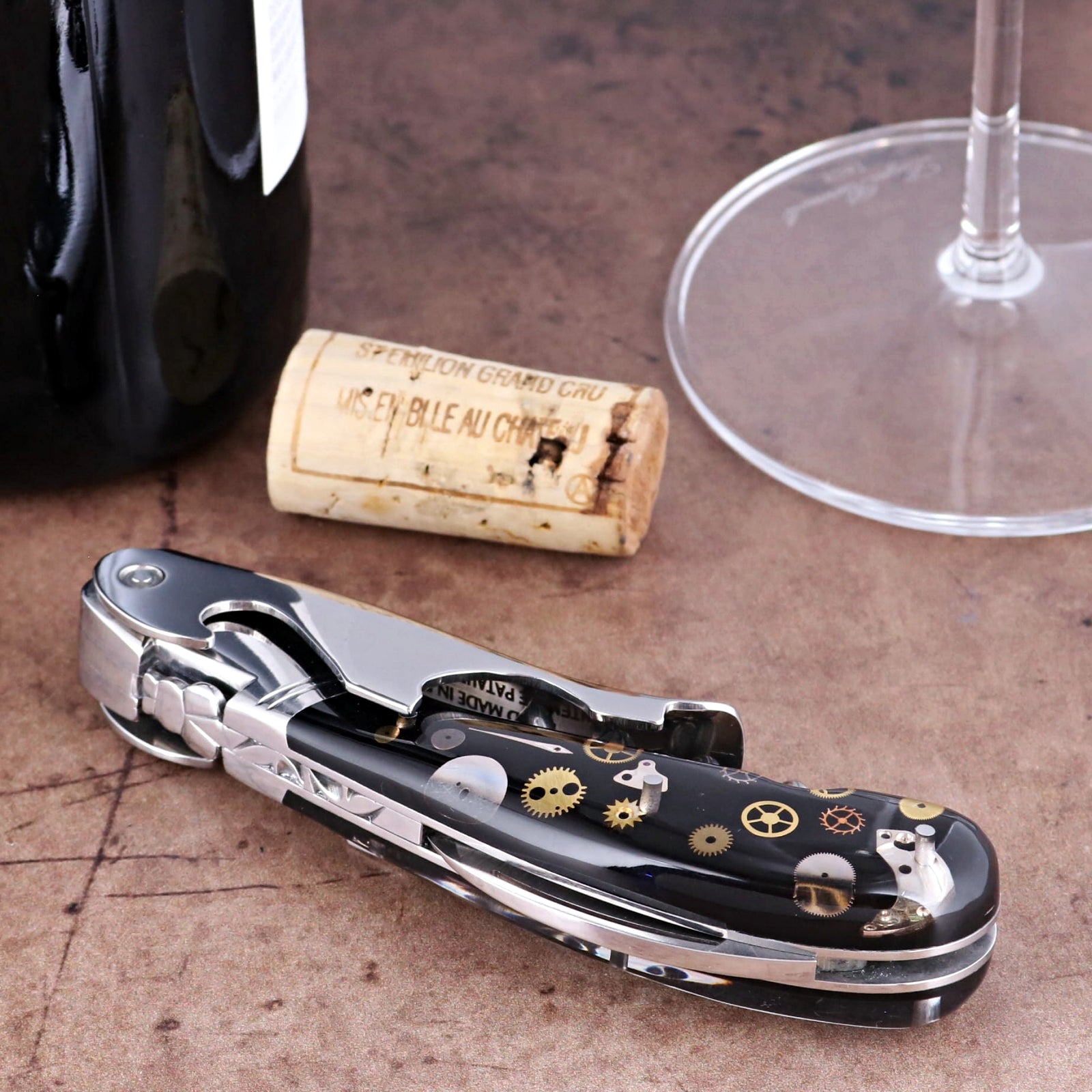 Laguiole Magnum Corkscrew close-up showing black handle with intricate gold and silver gear inlays.