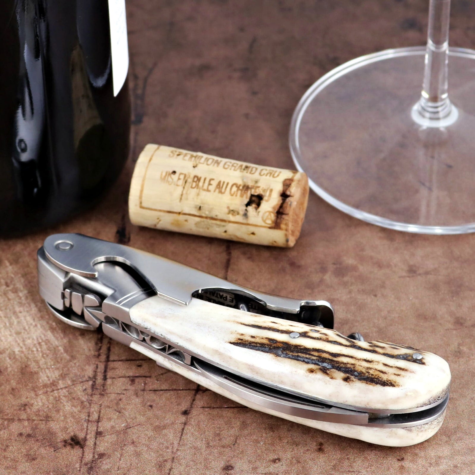 Laguiole Magnum Deer Stag Corkscrew, close-up of stainless steel tool with textured antler handle.