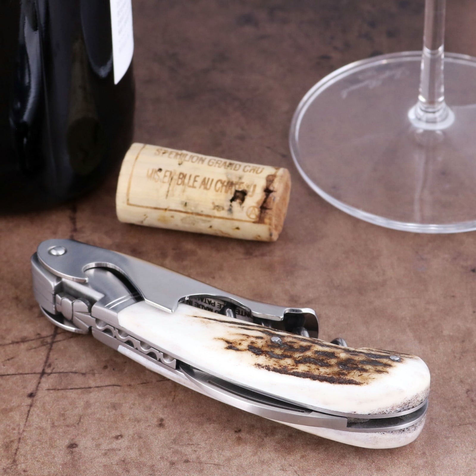 Laguiole Magnum Deer Stag Corkscrew, close-up of stainless steel tool with textured antler handle.