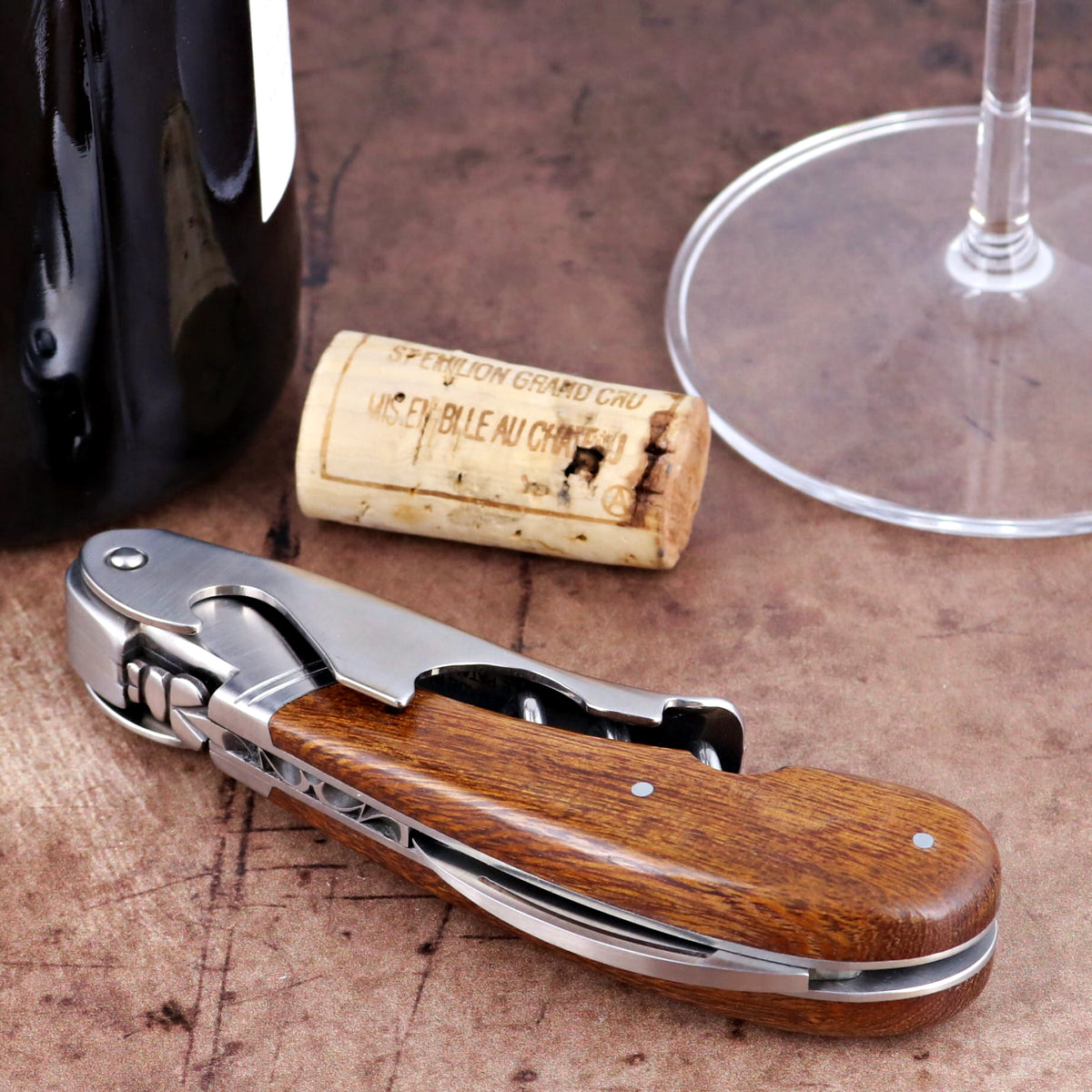 Laguiole Magnum Desert Ironwood corkscrew, close-up of polished steel and rich wood grain handle.