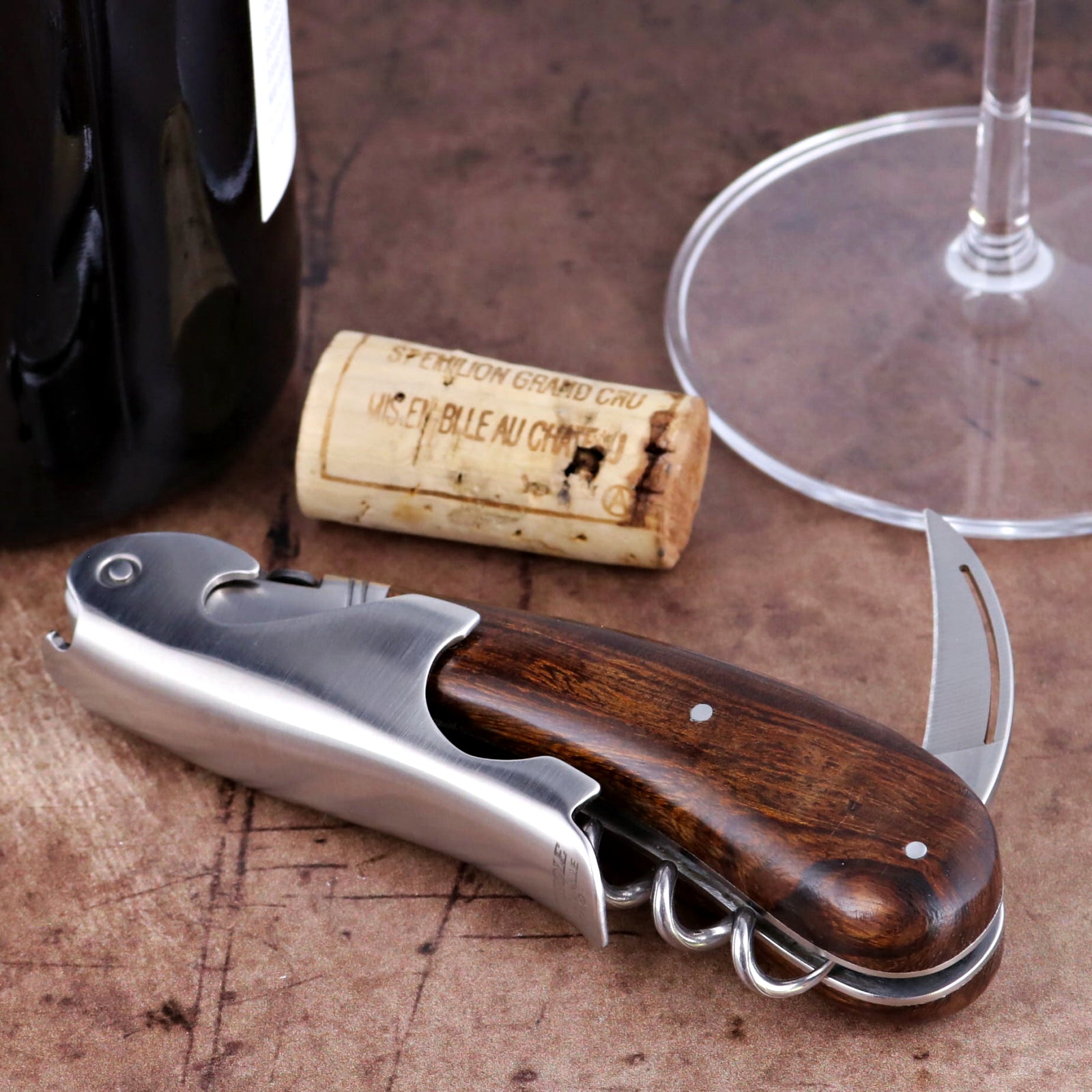Laguiole Magnum Desert Ironwood Corkscrew, close-up side view showing rich wood grain and steel frame.