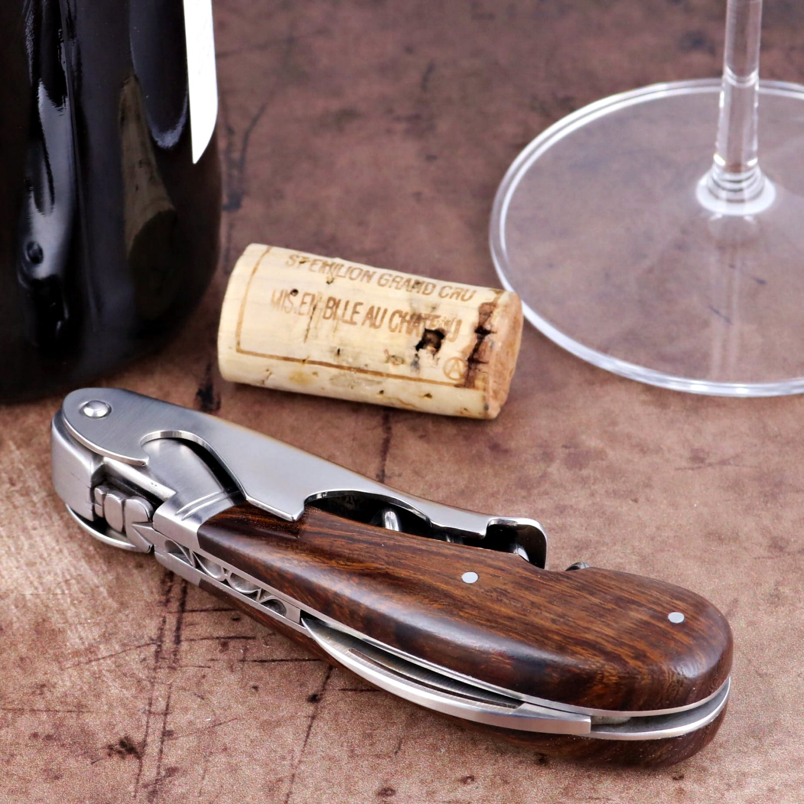 Laguiole Magnum Desert Ironwood Corkscrew, close-up side view showing rich wood grain and steel frame.