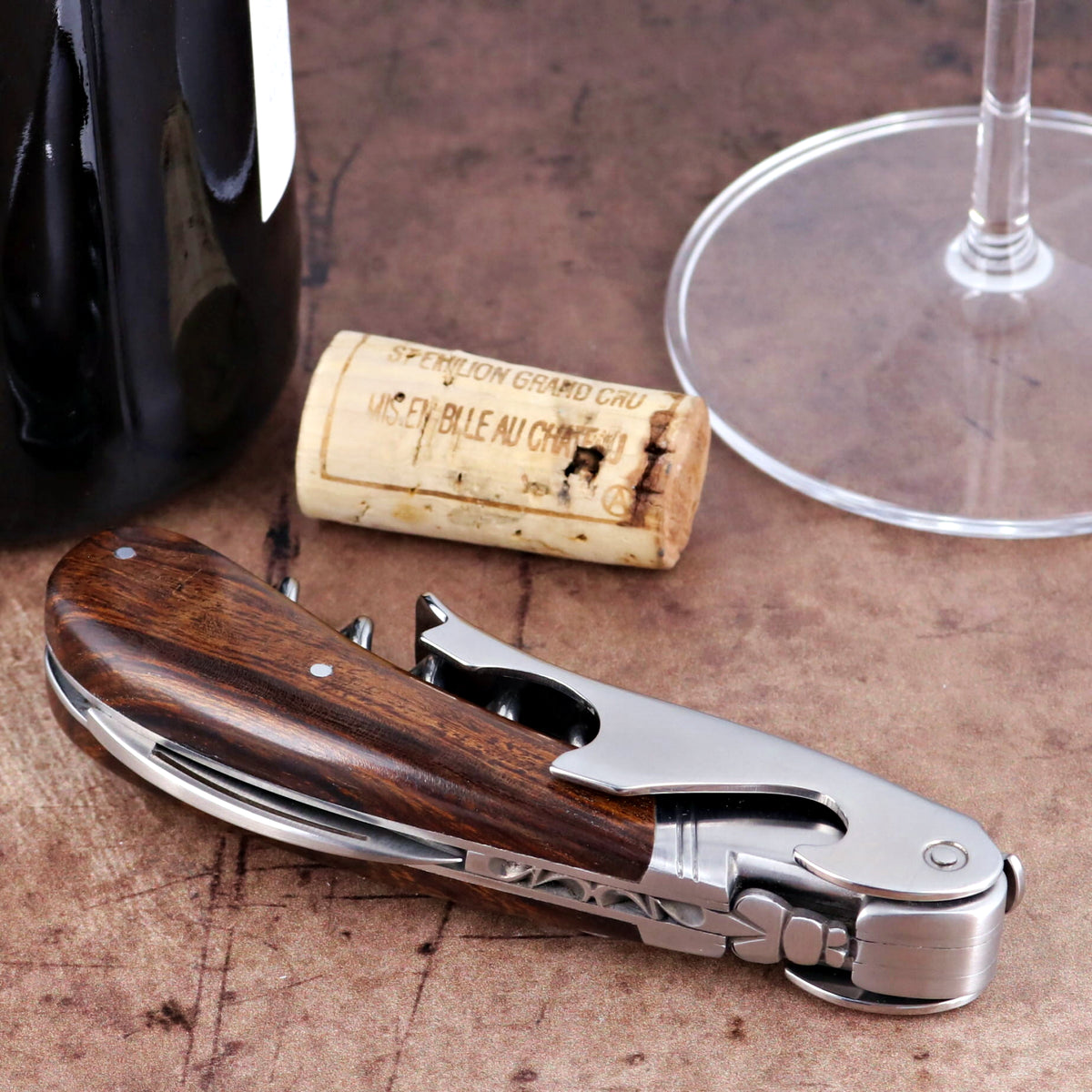 Laguiole Magnum Desert Ironwood Corkscrew close-up featuring polished steel and rich wood grain handle.