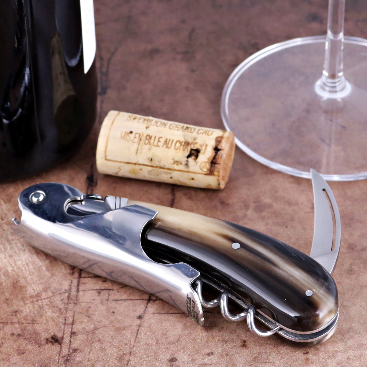 Laguiole Magnum Flamed Horn Tip corkscrew in a close-up side view with polished steel and horn handle.