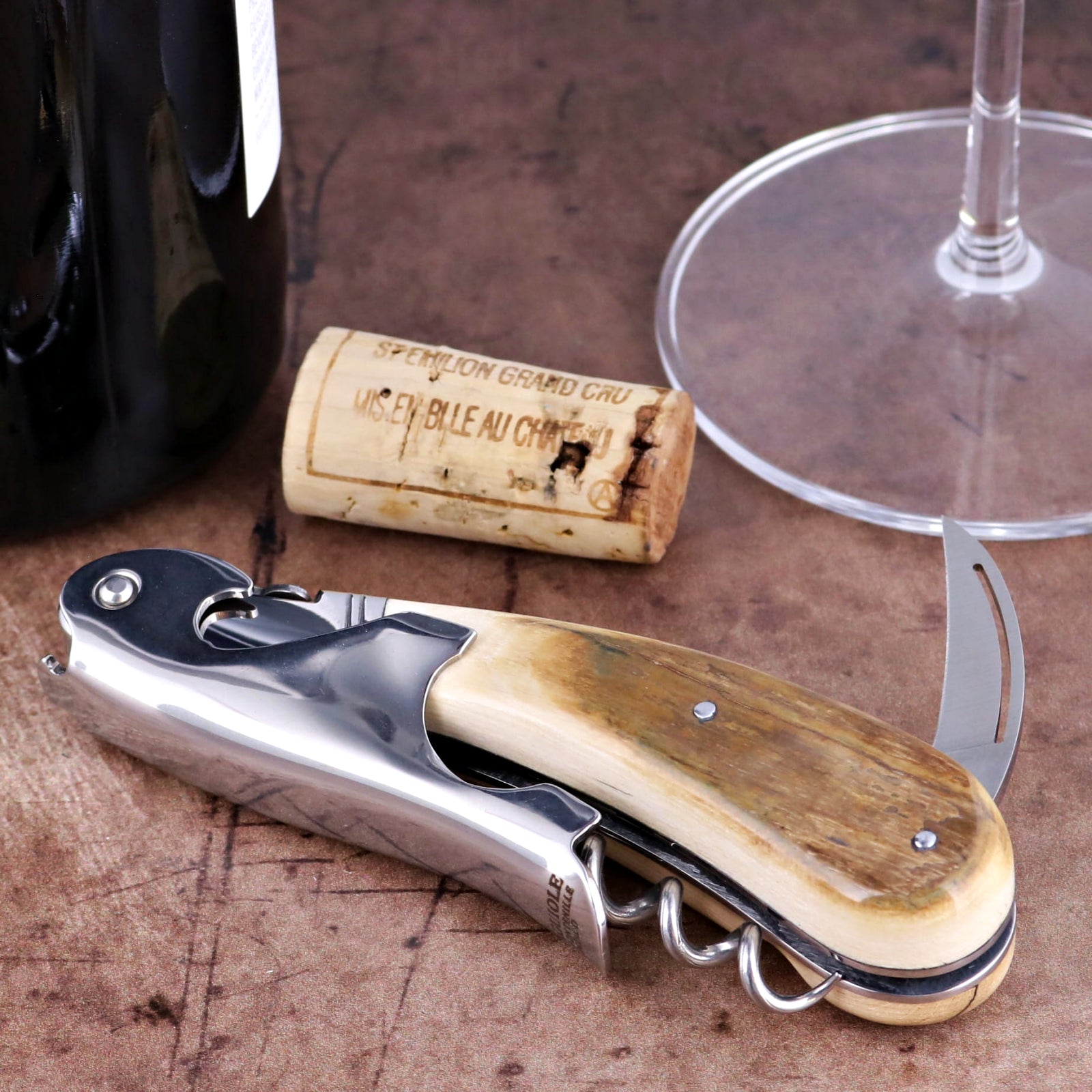 Laguiole Magnum Fossilized Mammoth Ivory Corkscrew, close-up of cream handle with steel components.
