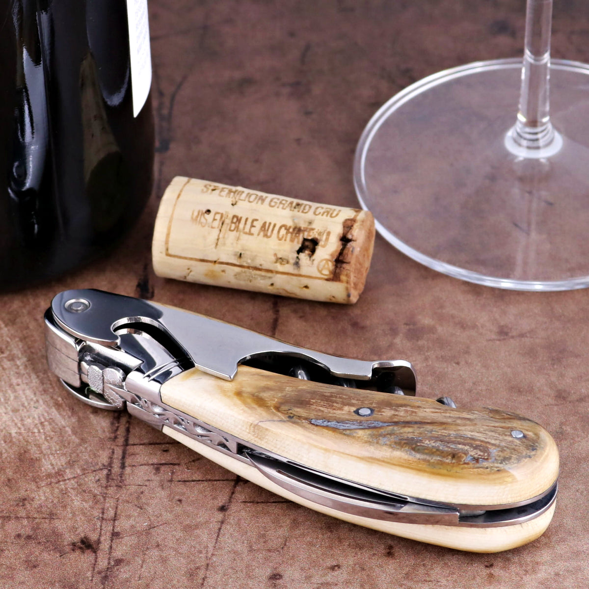 Laguiole Magnum Fossilized Mammoth Ivory Corkscrew, close-up of polished ivory handle and steel frame.