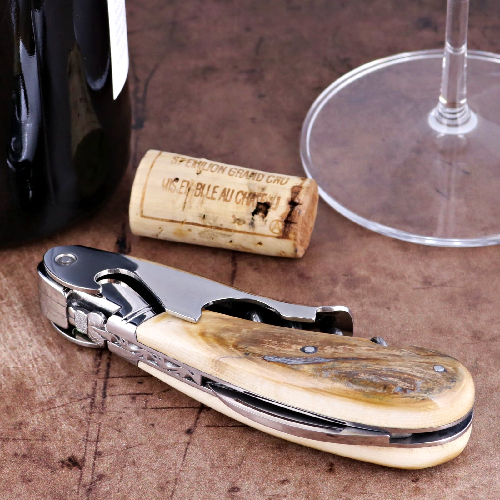 Laguiole Magnum Fossilized Mammoth Ivory Corkscrew, close-up of cream handle with steel components.