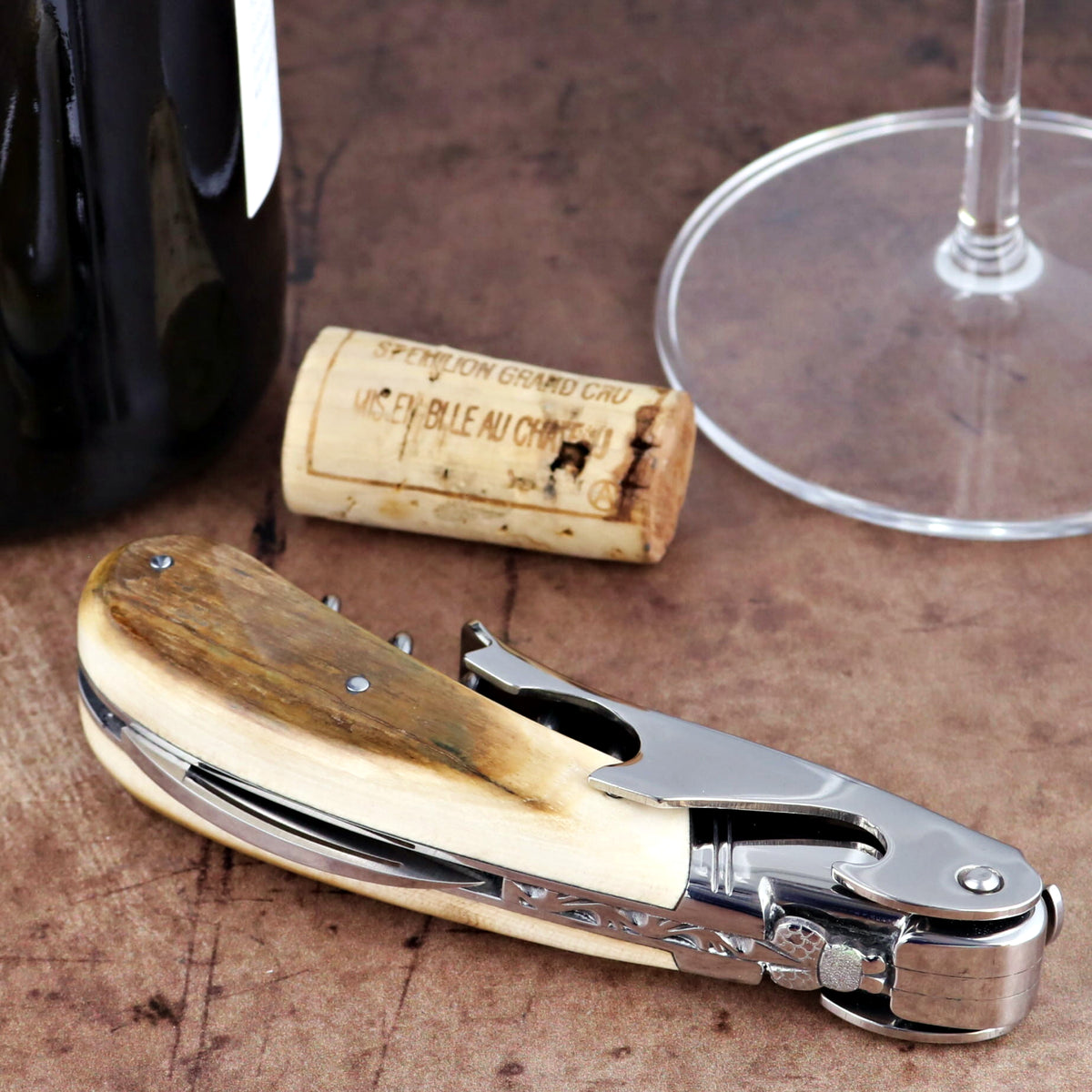 Laguiole Magnum Fossilized Mammoth Ivory Corkscrew, close-up of cream-toned handle and steel bolster.