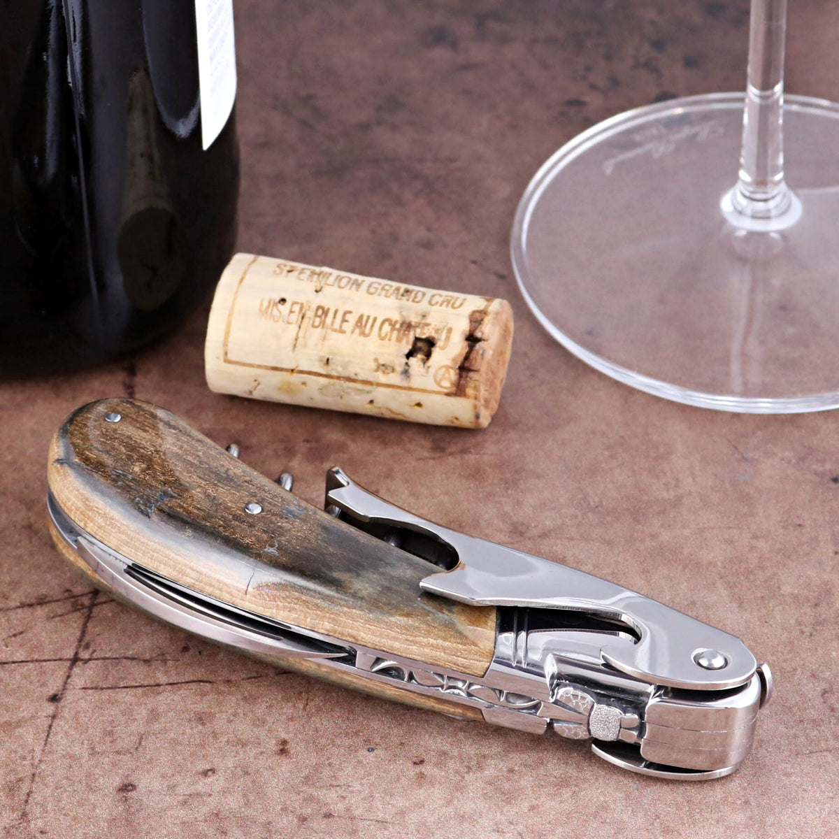 Laguiole Magnum Fossilized Mammoth Ivory Corkscrew, close-up side view of polished steel and ivory.