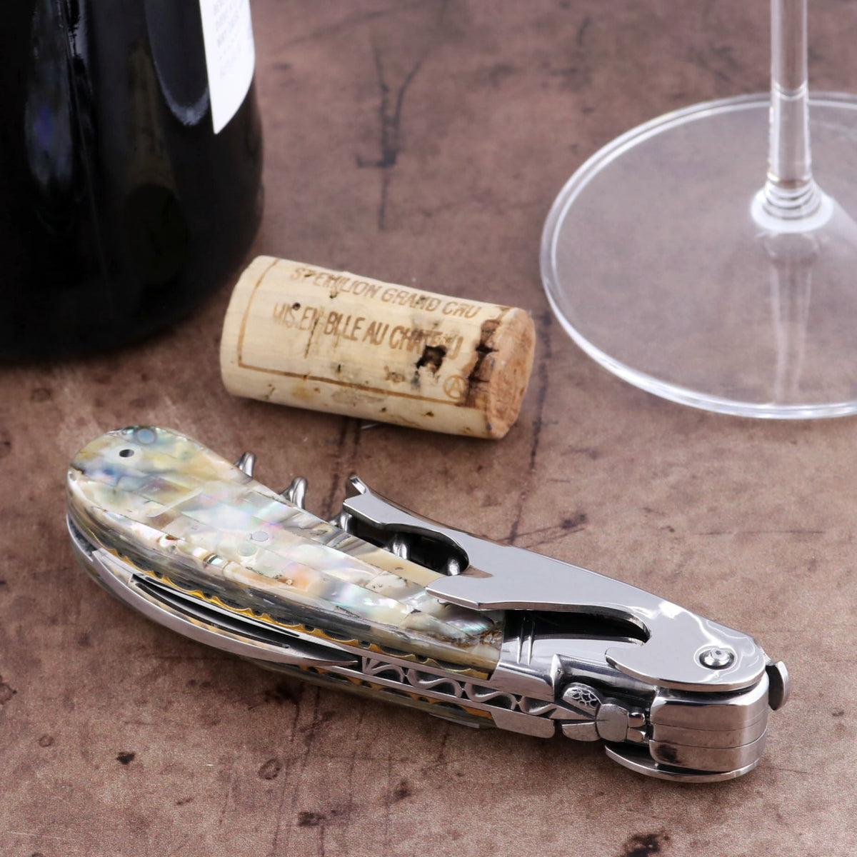 Laguiole Magnum Genuine Mother of Pearl Guilloche Corkscrew, close-up of iridescent handle.