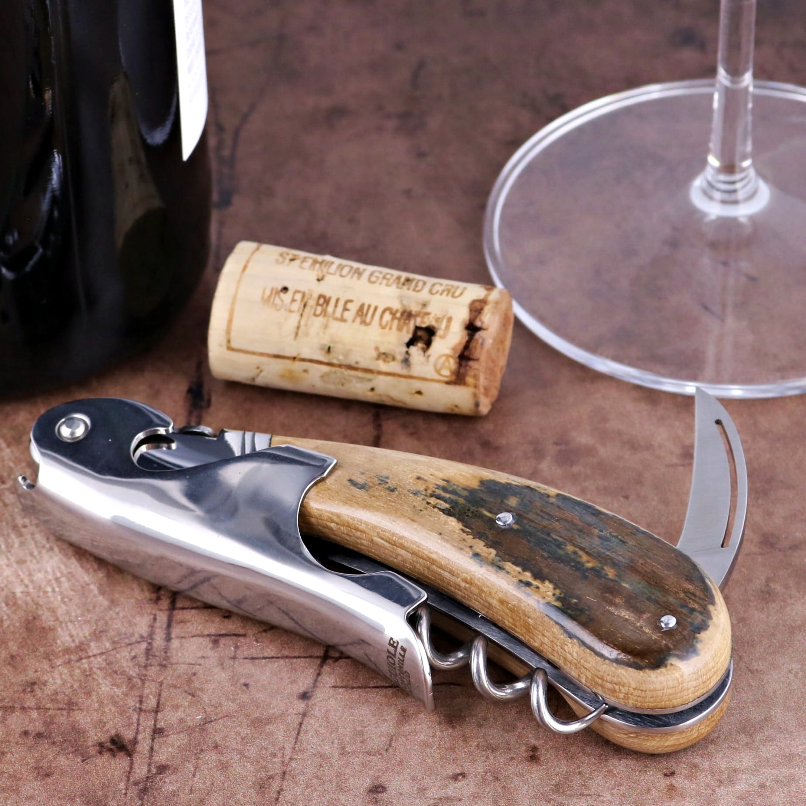 Laguiole Magnum Fossilized Mammoth Ivory Corkscrew, close-up of textured ivory handle and steel tool.