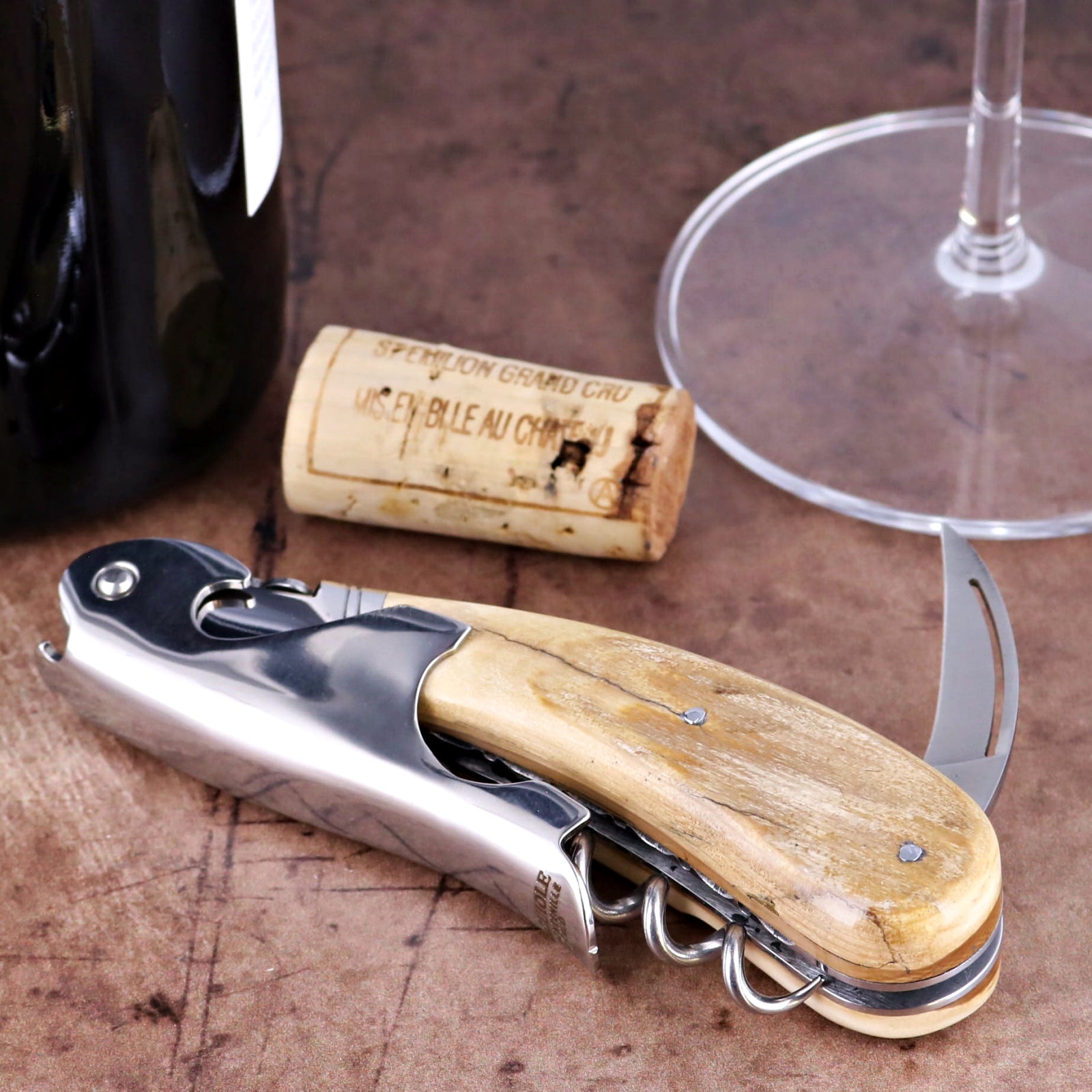 Laguiole Magnum Guilloche corkscrew, close-up of fossilized mammoth ivory handle and steel mechanism.