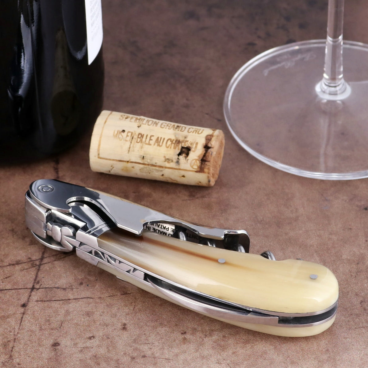 Laguiole Magnum Horn Tip Corkscrew, close-up side view of polished steel and cream horn handle.