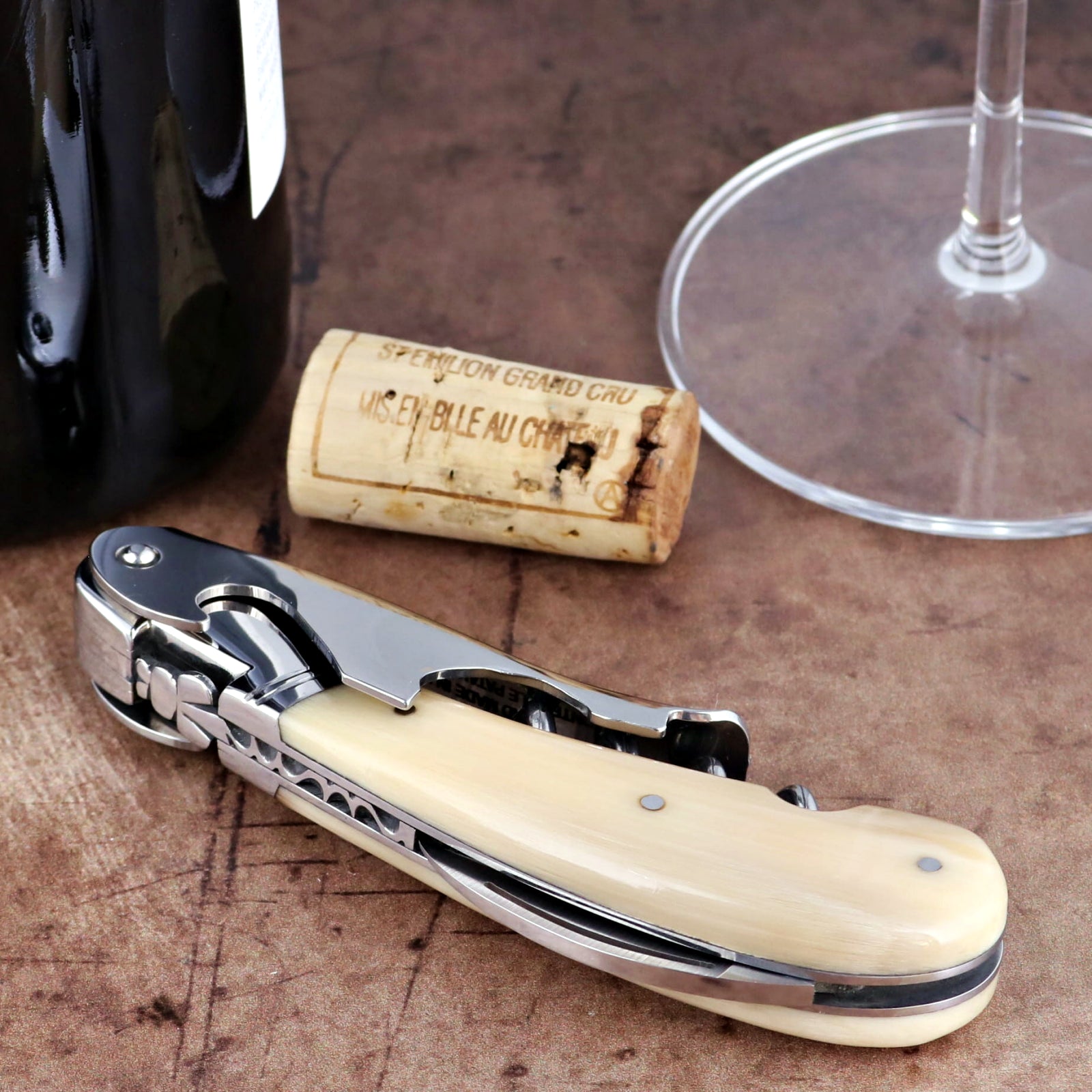 Laguiole Magnum Horn Tip Corkscrew, close-up of polished steel and cream horn handle with foil cutter.
