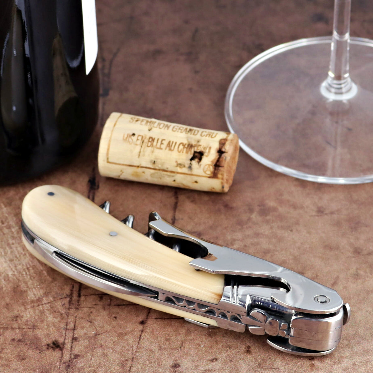 Laguiole Magnum Horn Tip Corkscrew, close-up of folded cream horn handle and polished steel mechanism.