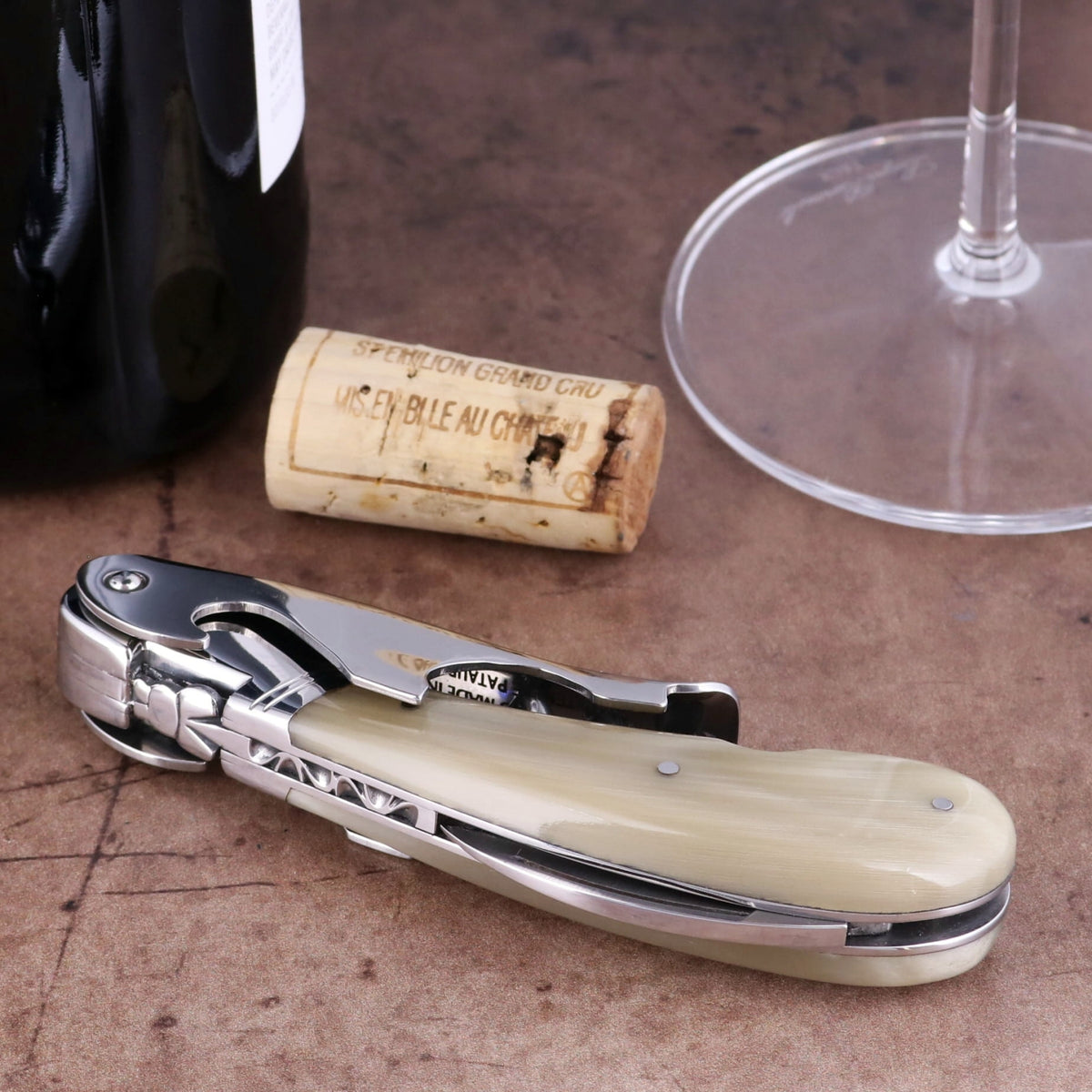 Laguiole Magnum Horn Tip Corkscrew close-up featuring a polished steel body and cream horn handle.