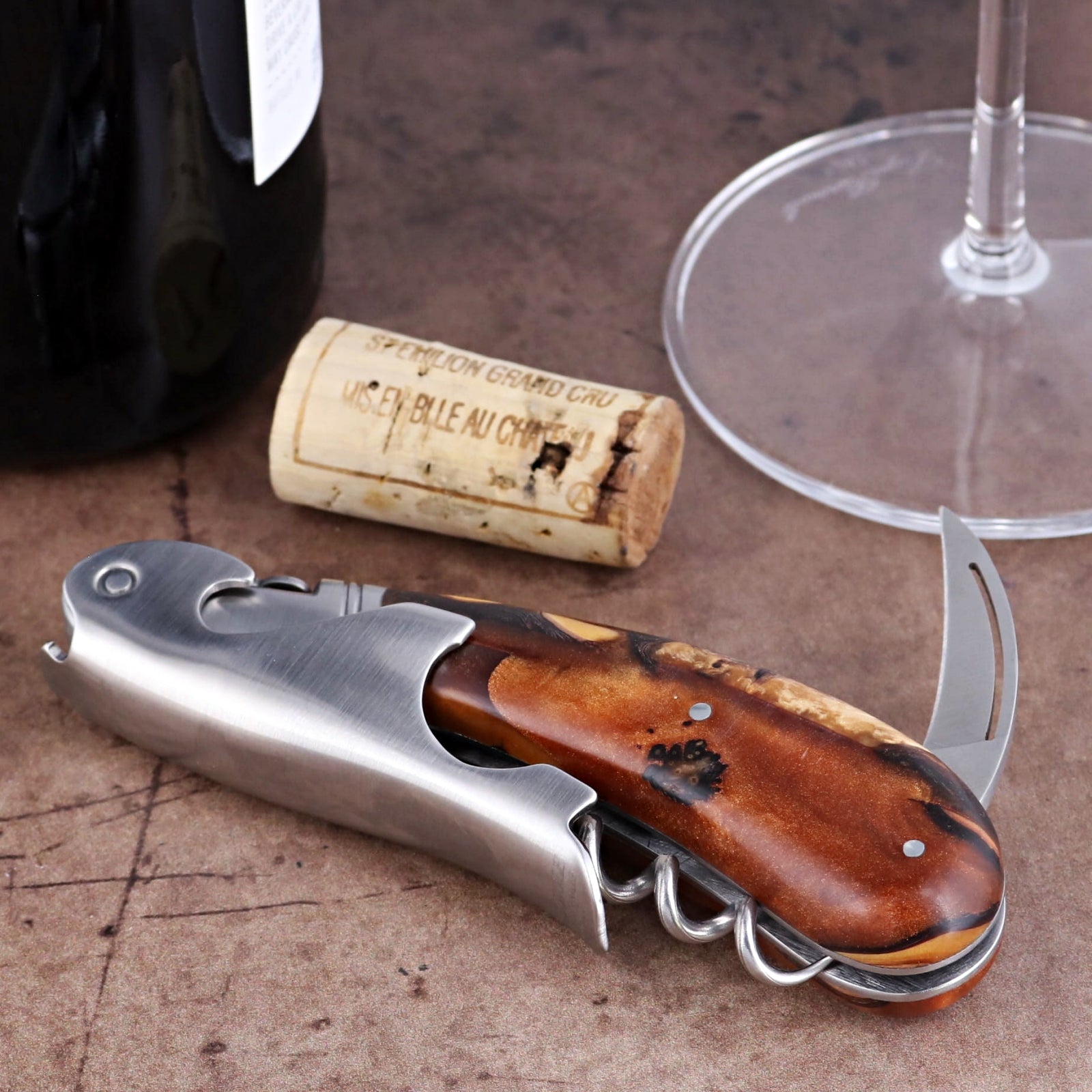 Laguiole Magnum Hybrid Juniper Burl Corkscrew close-up featuring a polished steel and wood handle.