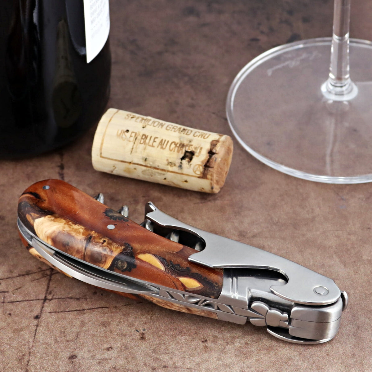 Laguiole Magnum Hybrid Juniper Burl Corkscrew, close-up side view of polished steel and wood handle.