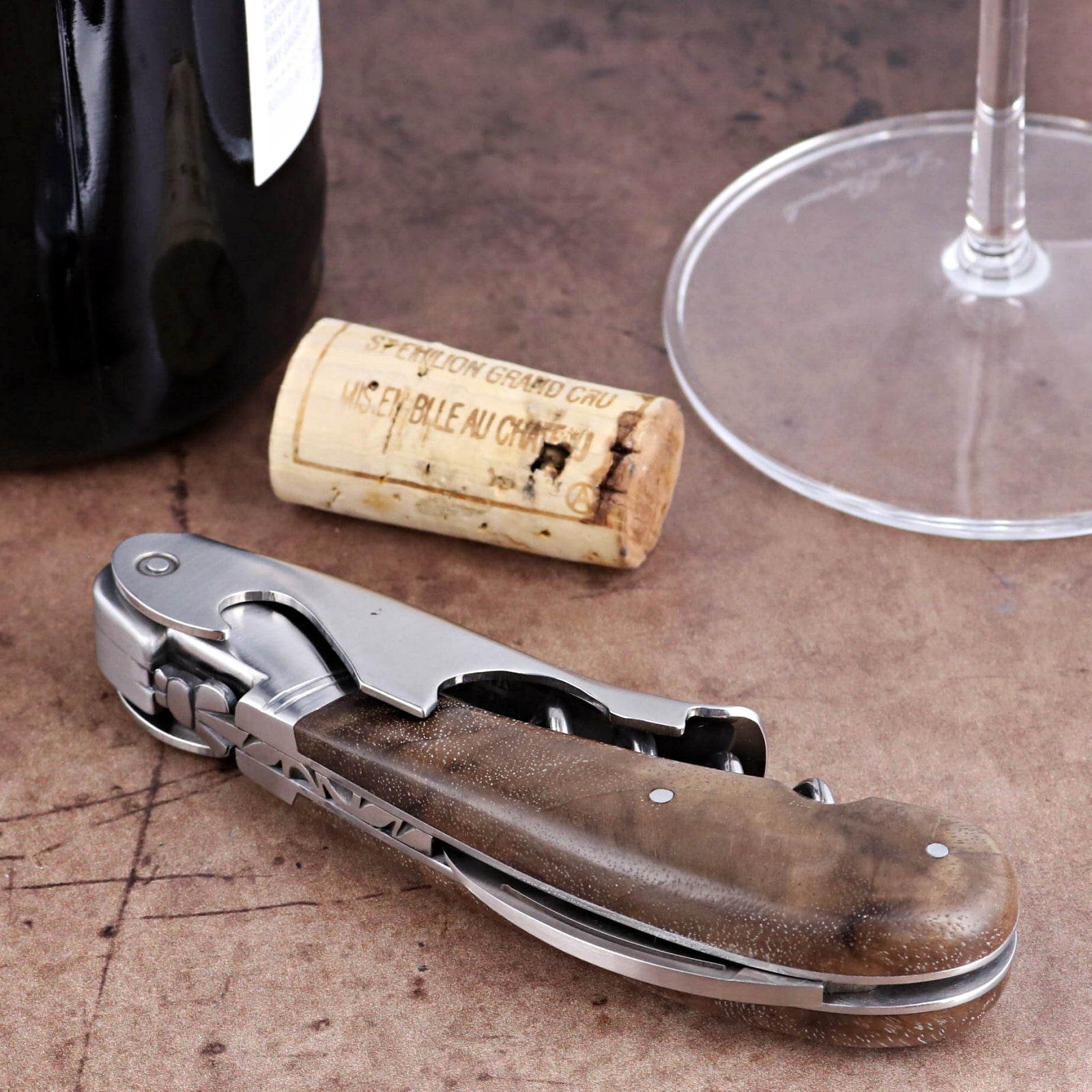 Laguiole Magnum Walnut Corkscrew, close-up of folded stainless steel tool with dark wood handle.