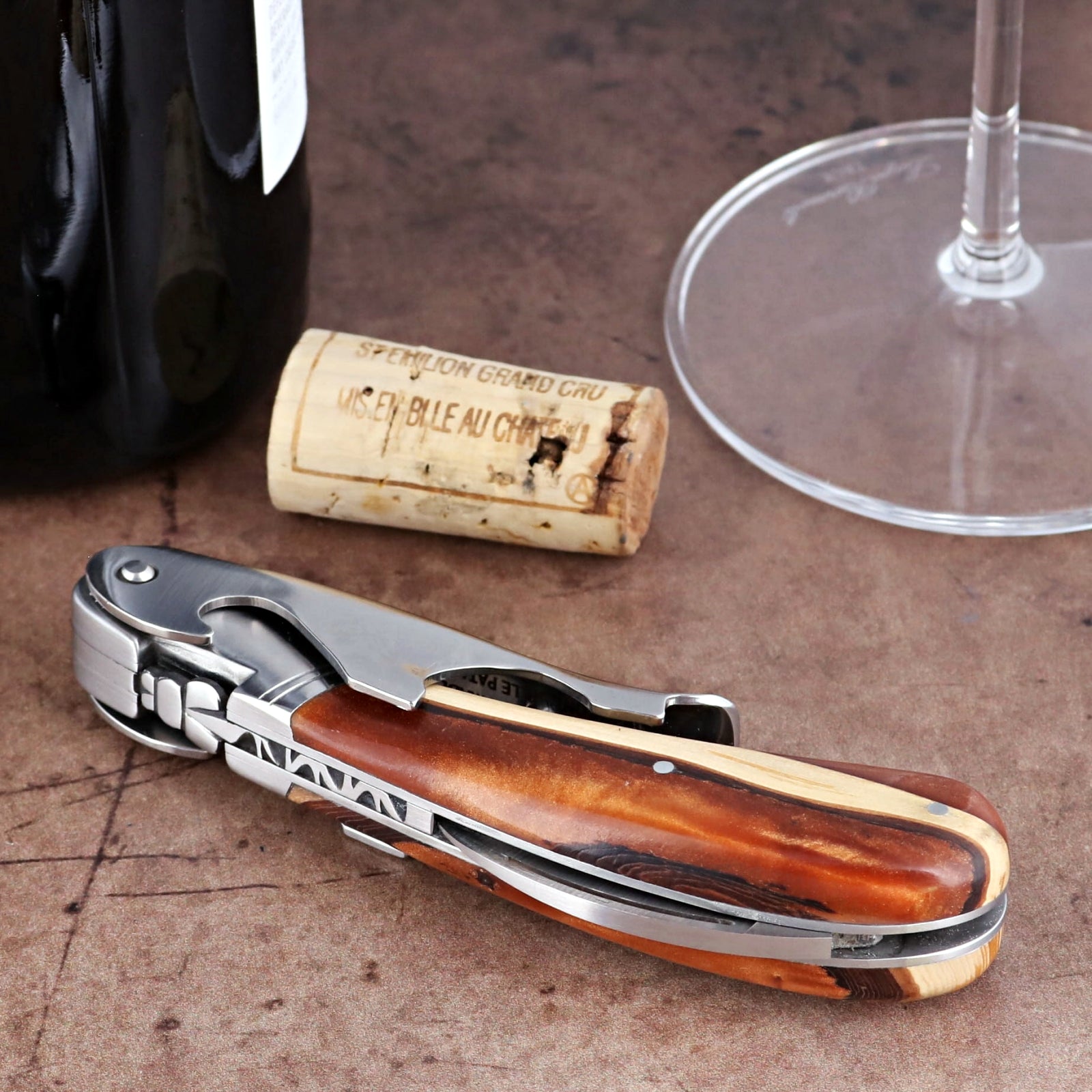 Laguiole Magnum Hybrid Juniper Burl corkscrew, close-up side view showing wood handle and steel frame.