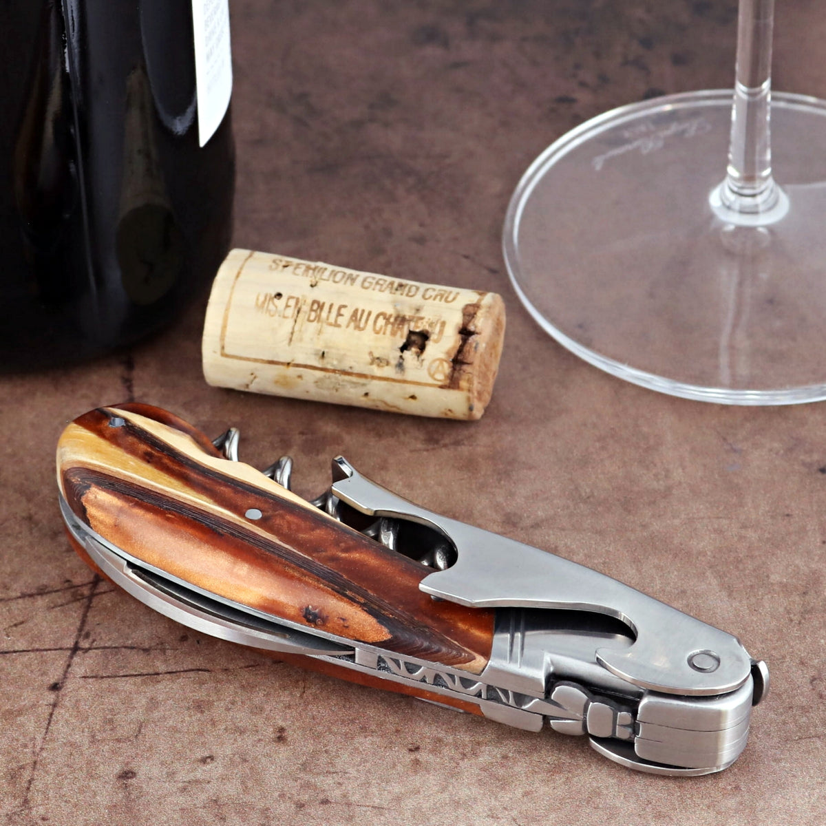 Laguiole Magnum Hybrid Juniper Burl Corkscrew, close-up of folded stainless steel and wood handle.