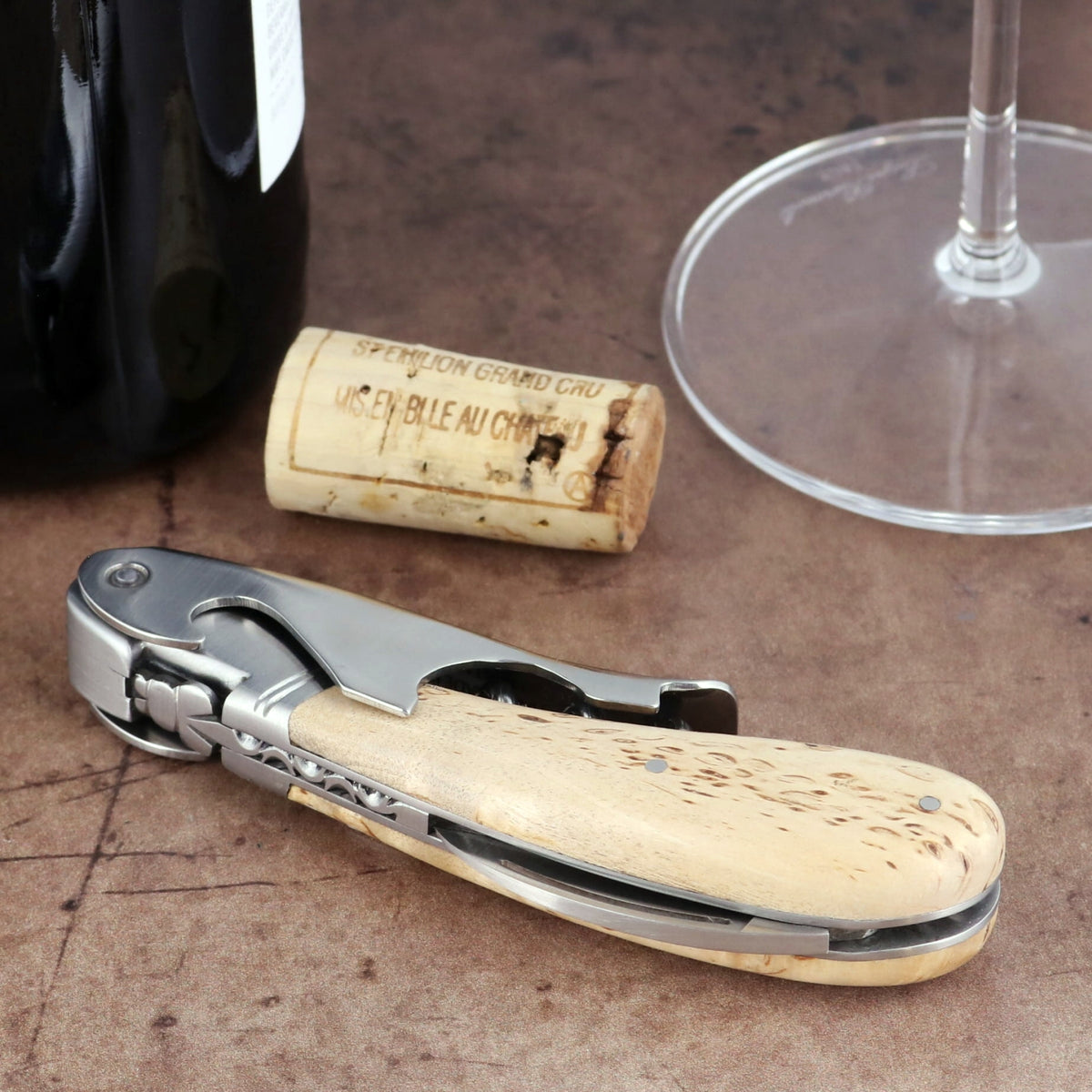 Laguiole Magnum Karelian Birch Corkscrew, close-up side view showing light wood handle and steel frame.