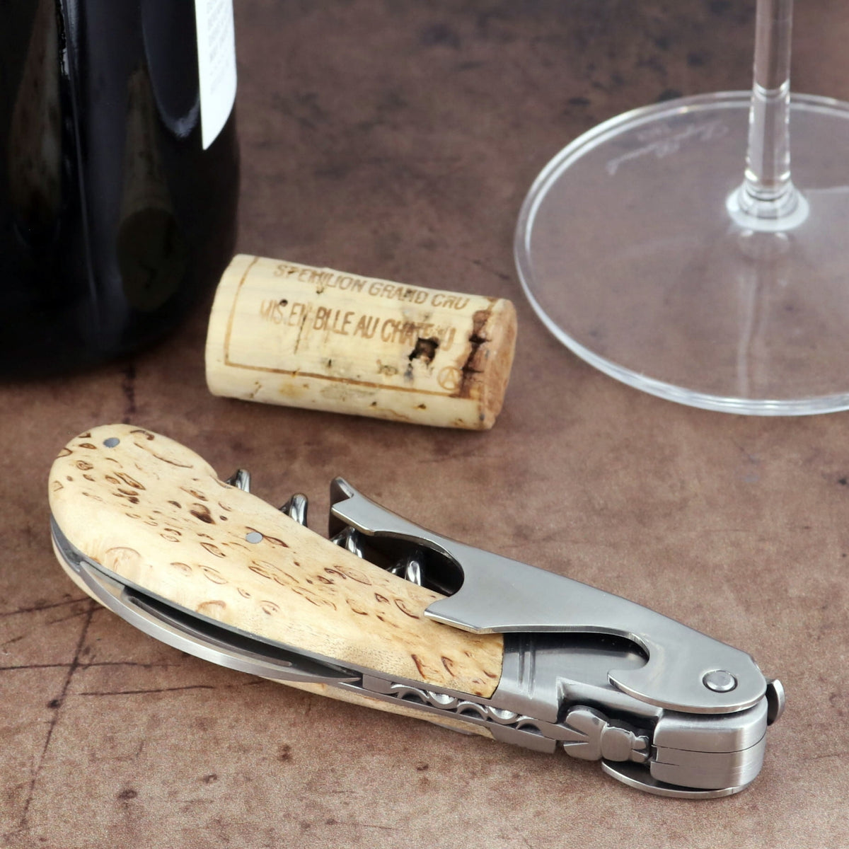Laguiole Magnum Karelian Birch Corkscrew close-up featuring a polished steel body and wood handle.
