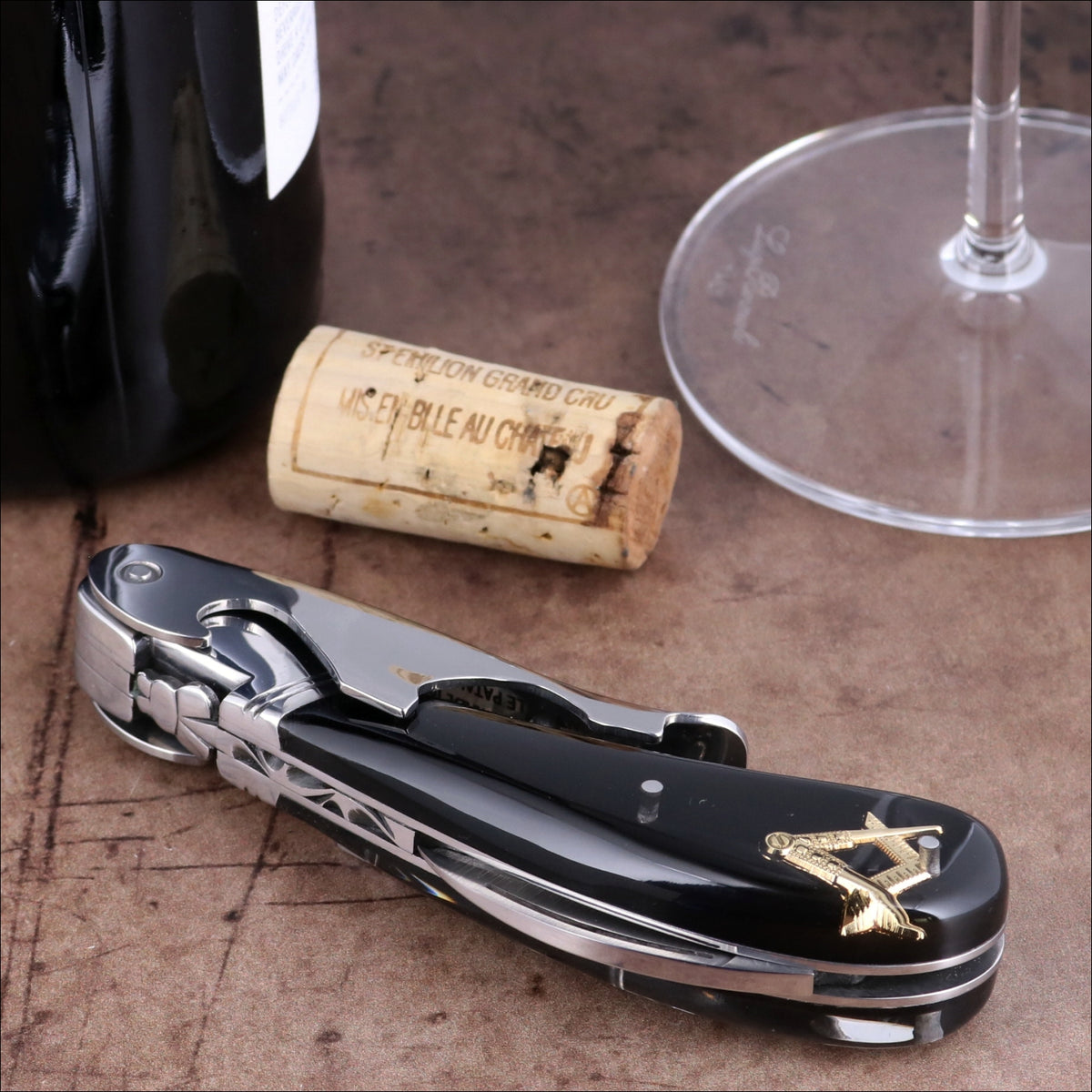Laguiole Magnum Masonic corkscrew close-up featuring a polished black handle with gold inlay detail.