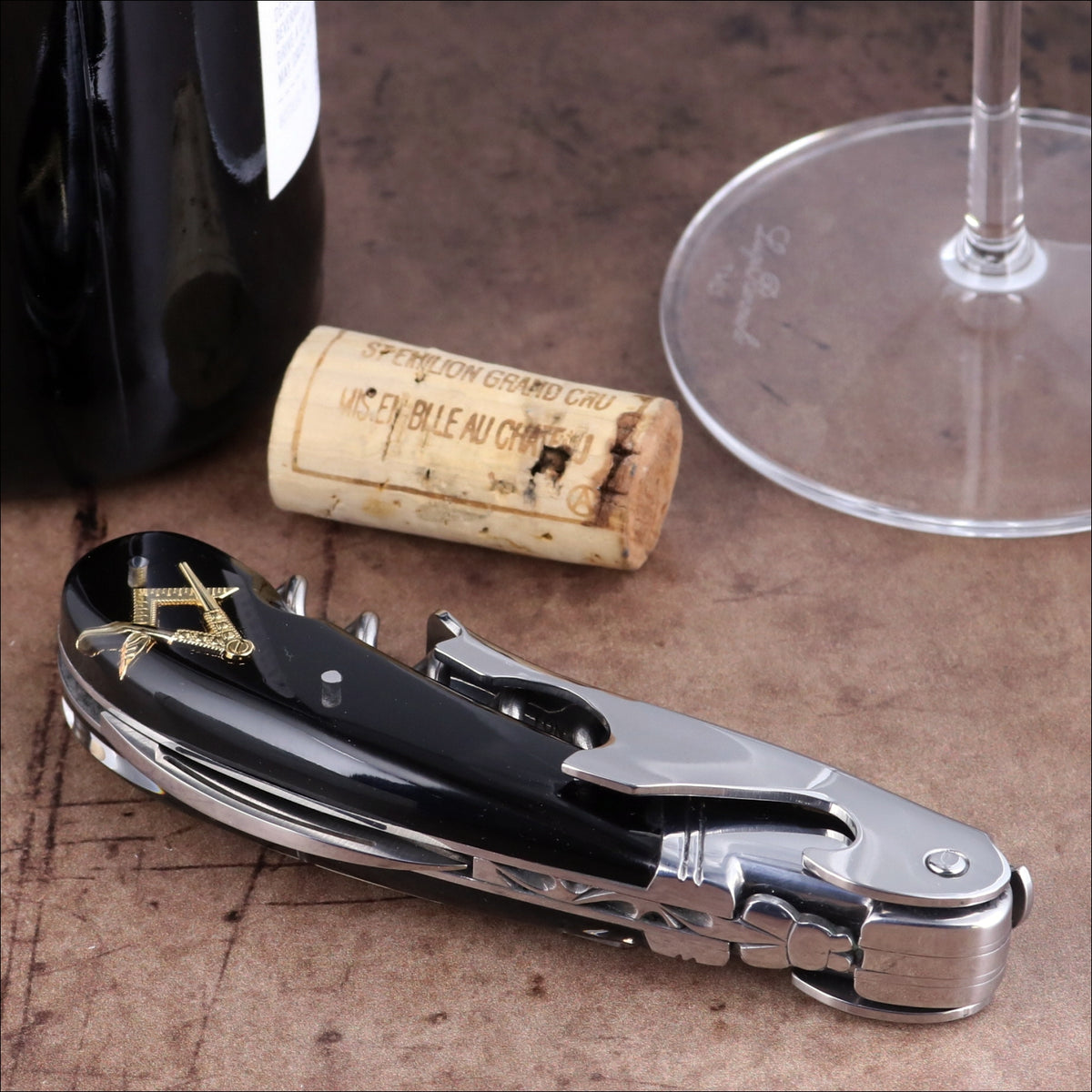 Laguiole Magnum Masonic corkscrew, close-up of black handle with gold square and compass inlay.