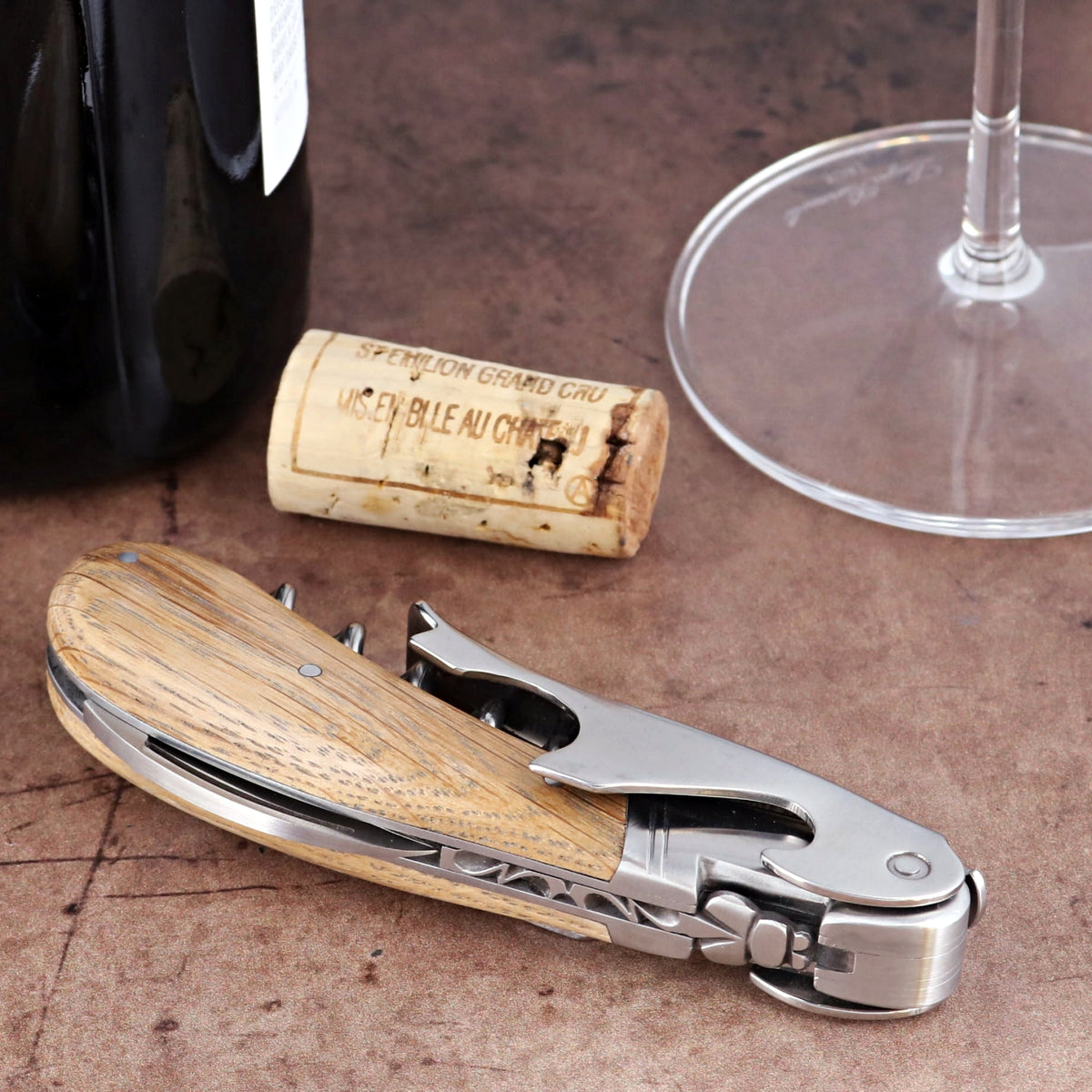 Laguiole Magnum Oak Barrel Wood Corkscrew, close-up of folded stainless steel tool with oak handle.