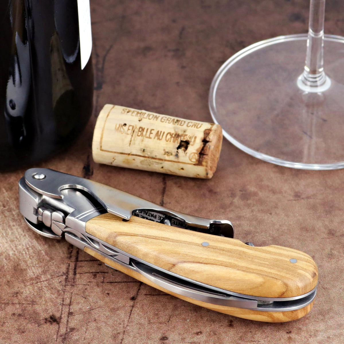Laguiole Magnum Olive Wood Corkscrew, close-up side view of the polished steel and wood handle.