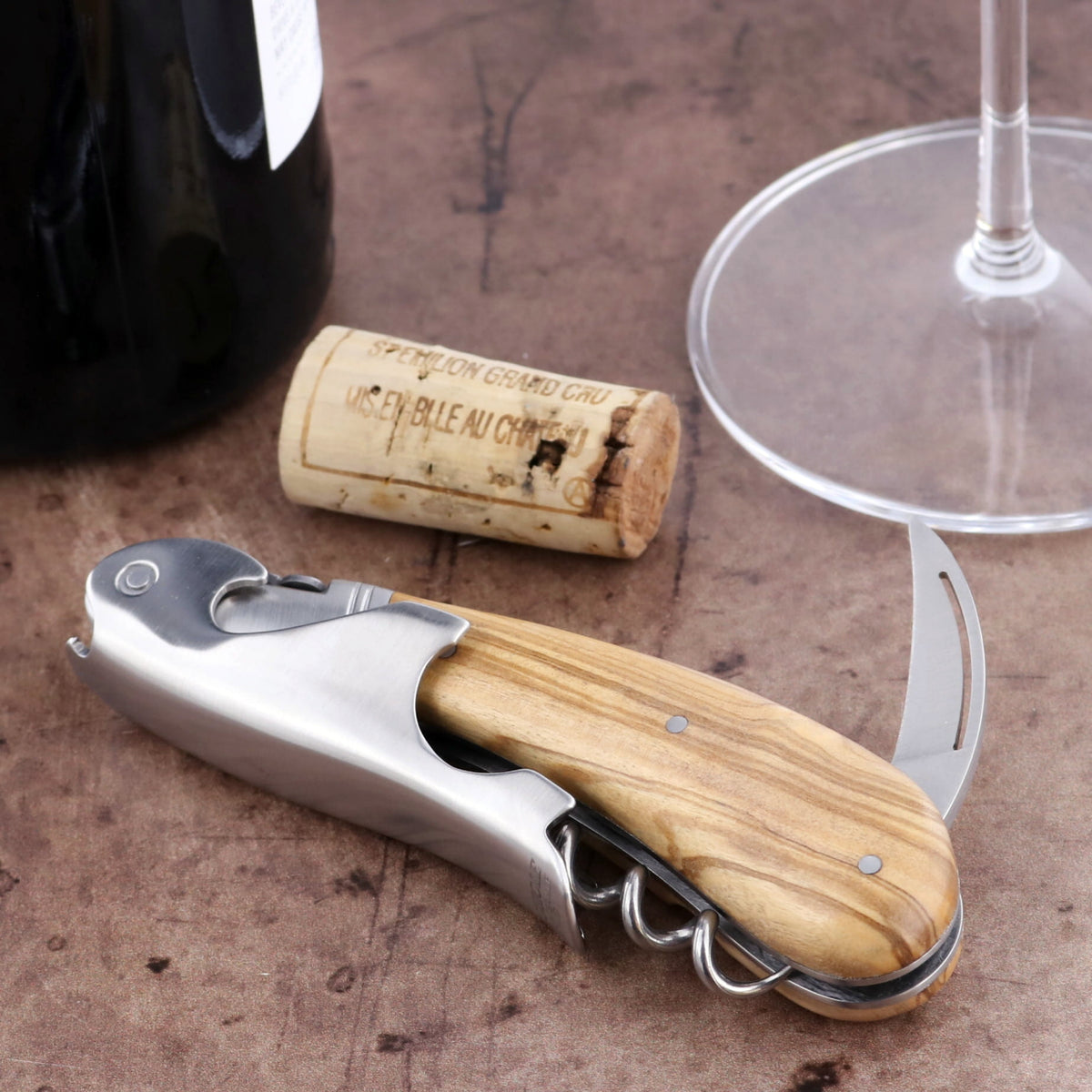 Laguiole Magnum Olive Wood Corkscrew, close-up of the natural wood handle and stainless steel tools.