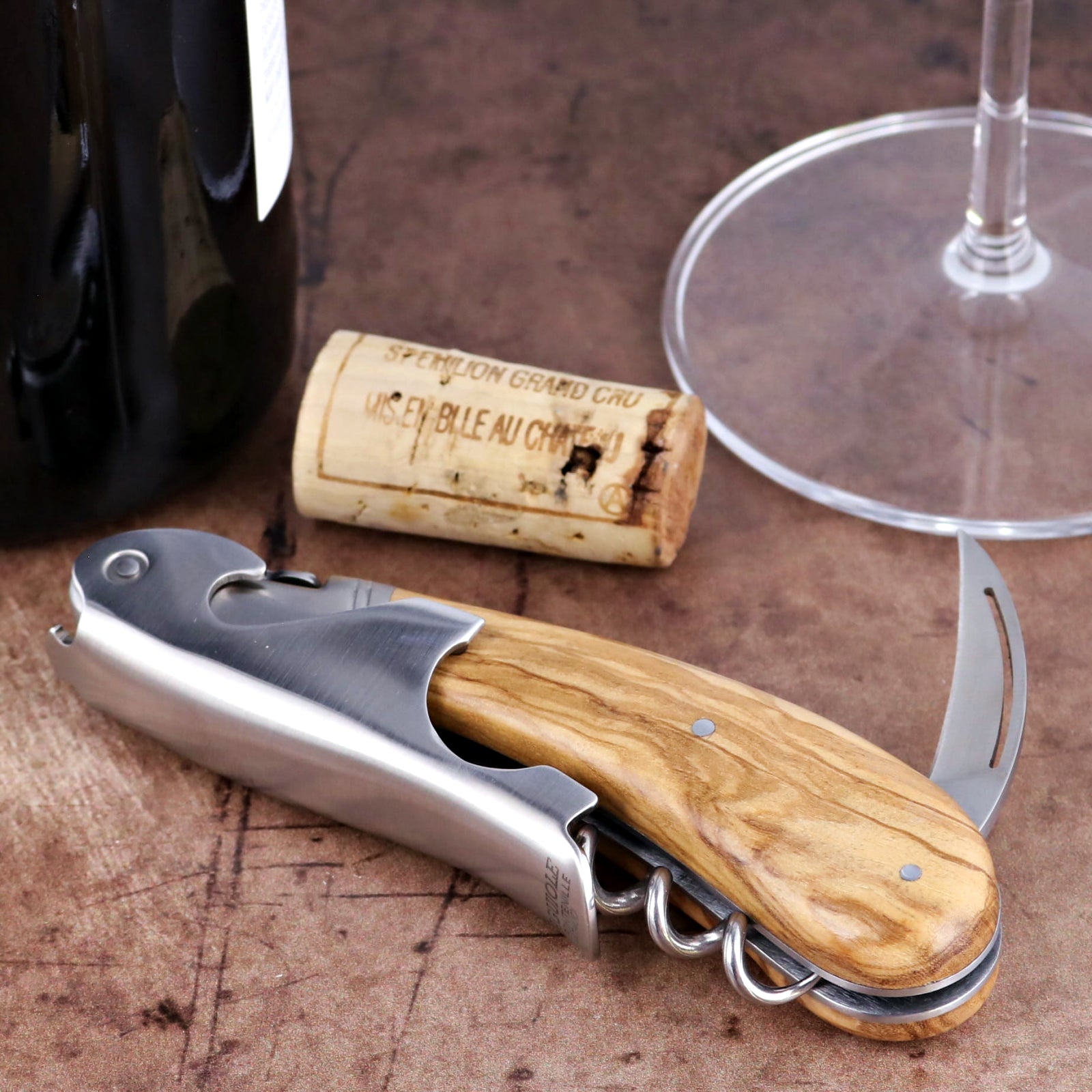Laguiole Magnum Olive Wood Corkscrew, close-up of stainless steel tool with natural olive wood handle.
